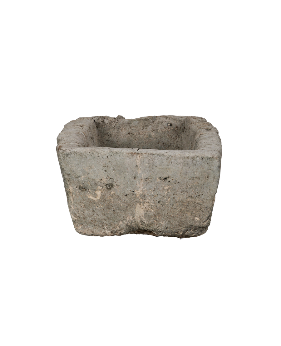 Vintage Indonesian OAK limestone trough, showing weathered texture and rectangular shape from an elevated angle.