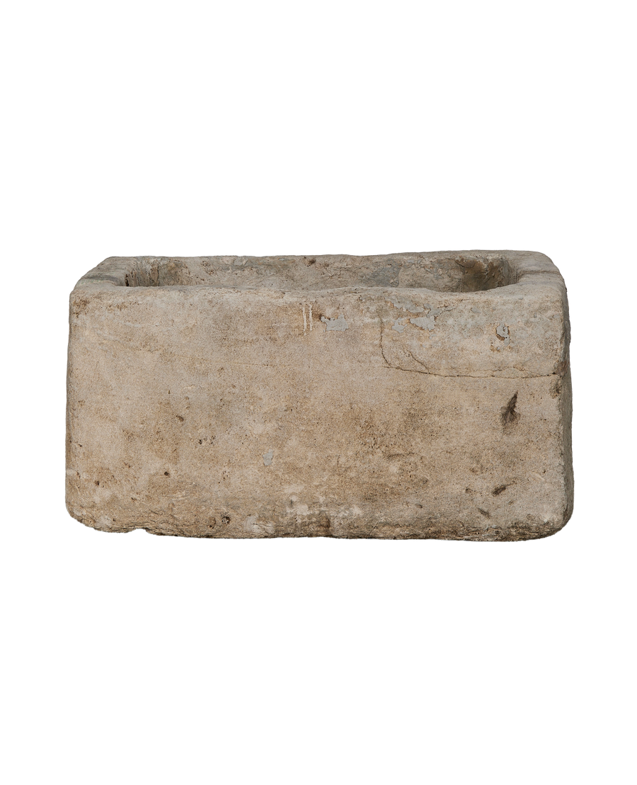 Vintage Indonesian limestone trough showing weathered light gray texture and worn edges.