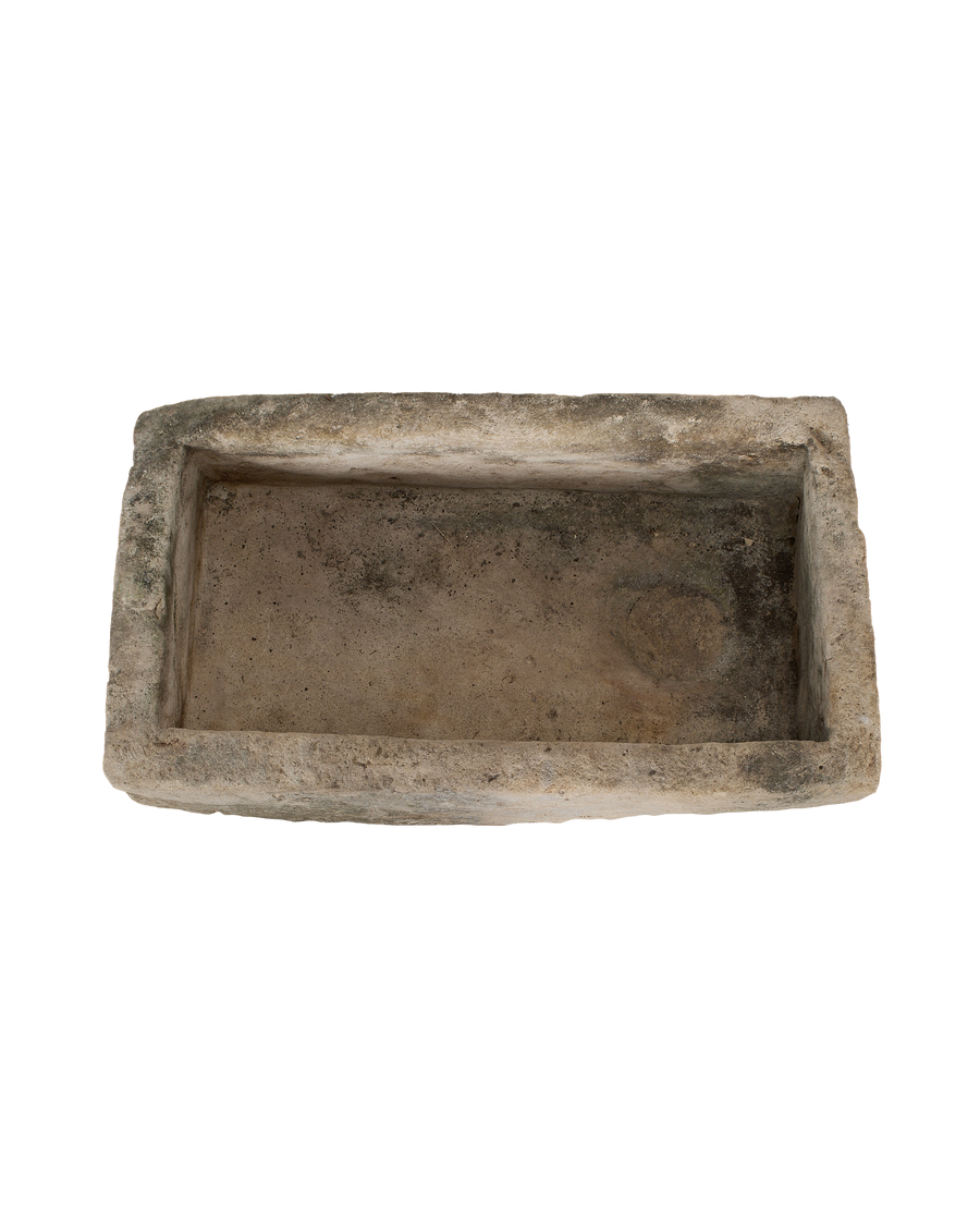 Vintage Indonesian limestone trough, top-down view showing interior basin, varying texture.