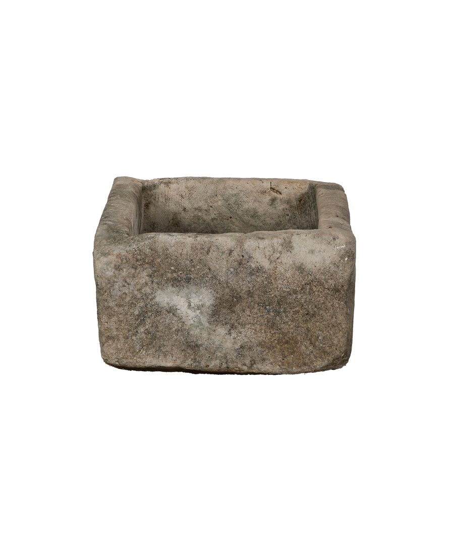 Vintage Indonesian limestone trough showing weathered, textured surface and rectangular shape.