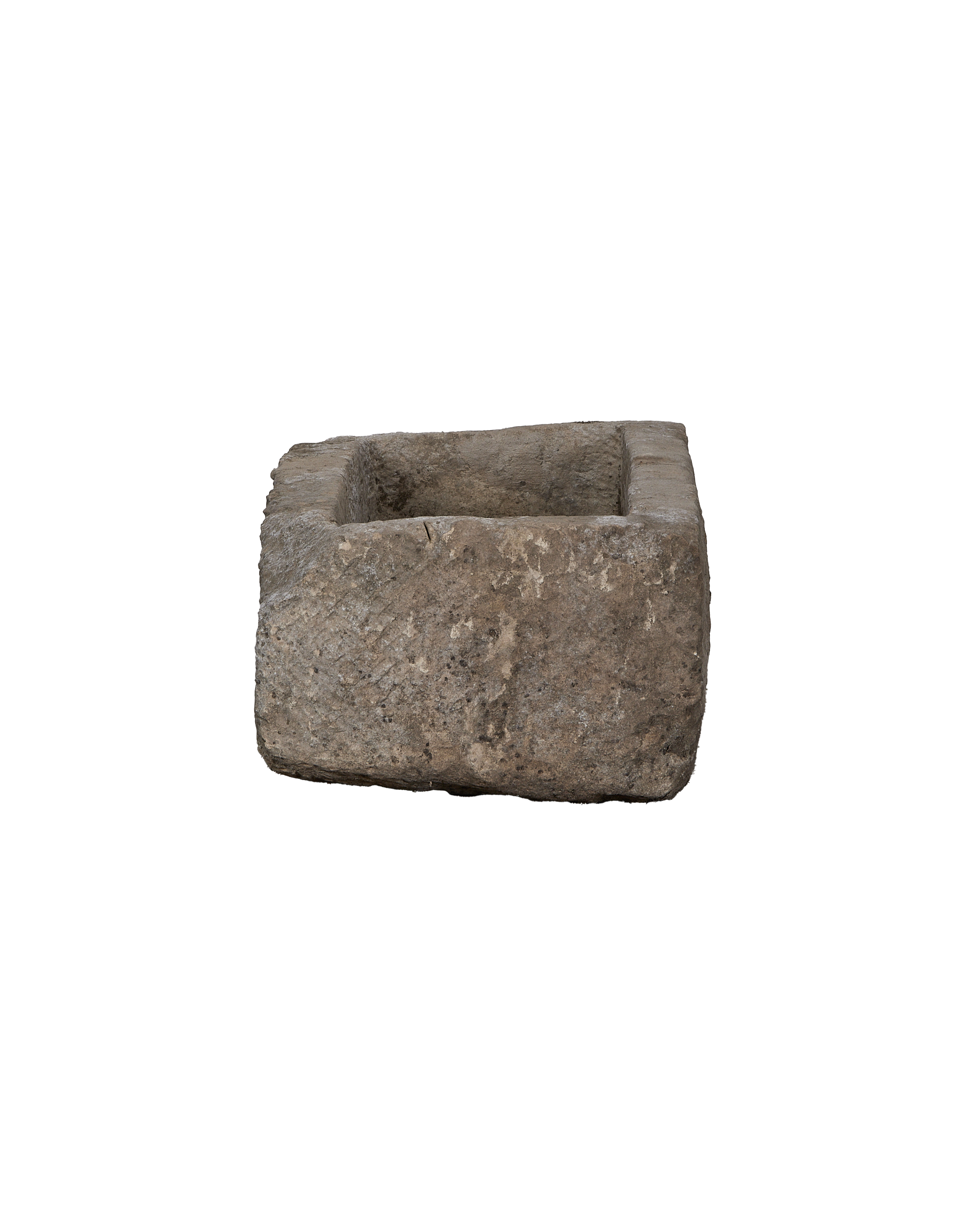 Vintage rectangular limestone trough, showing rough textured exterior and deep interior from slight angle.