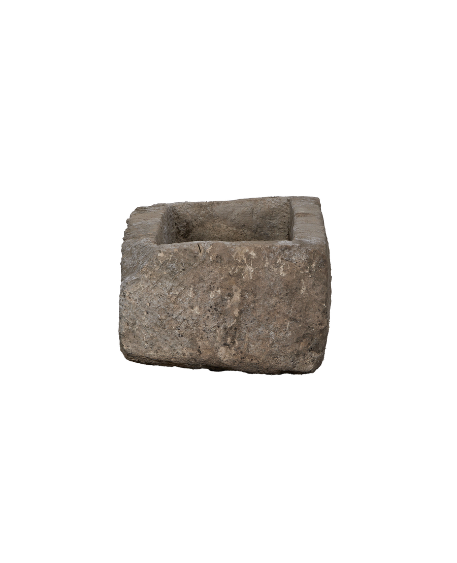 Vintage rectangular limestone trough, showing rough textured exterior and deep interior from slight angle.