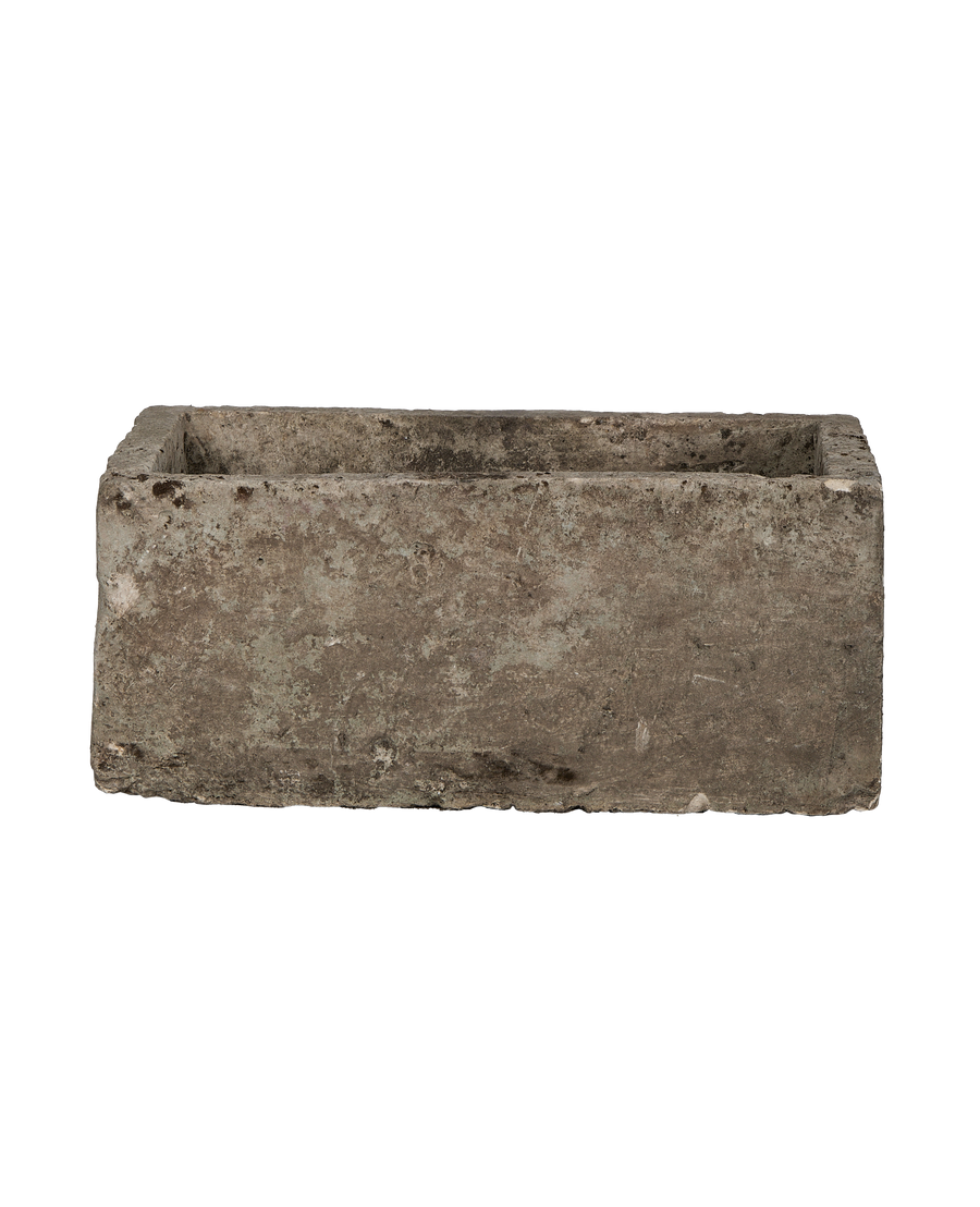 Vintage rectangular limestone trough, showing rough textured exterior and earthy tones.