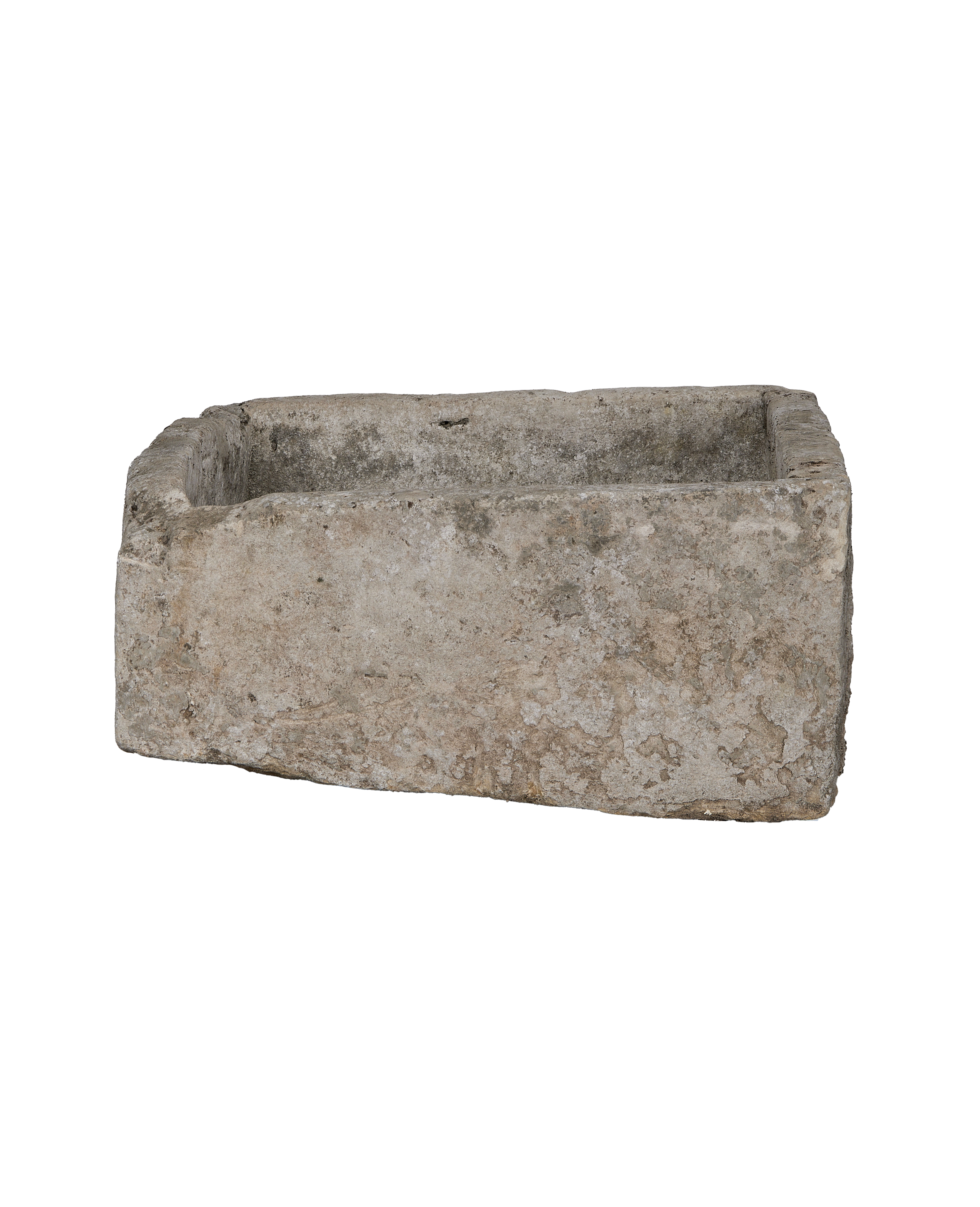 Vintage rectangular limestone trough, showcasing weathered stone texture and rough edges from a side angle.