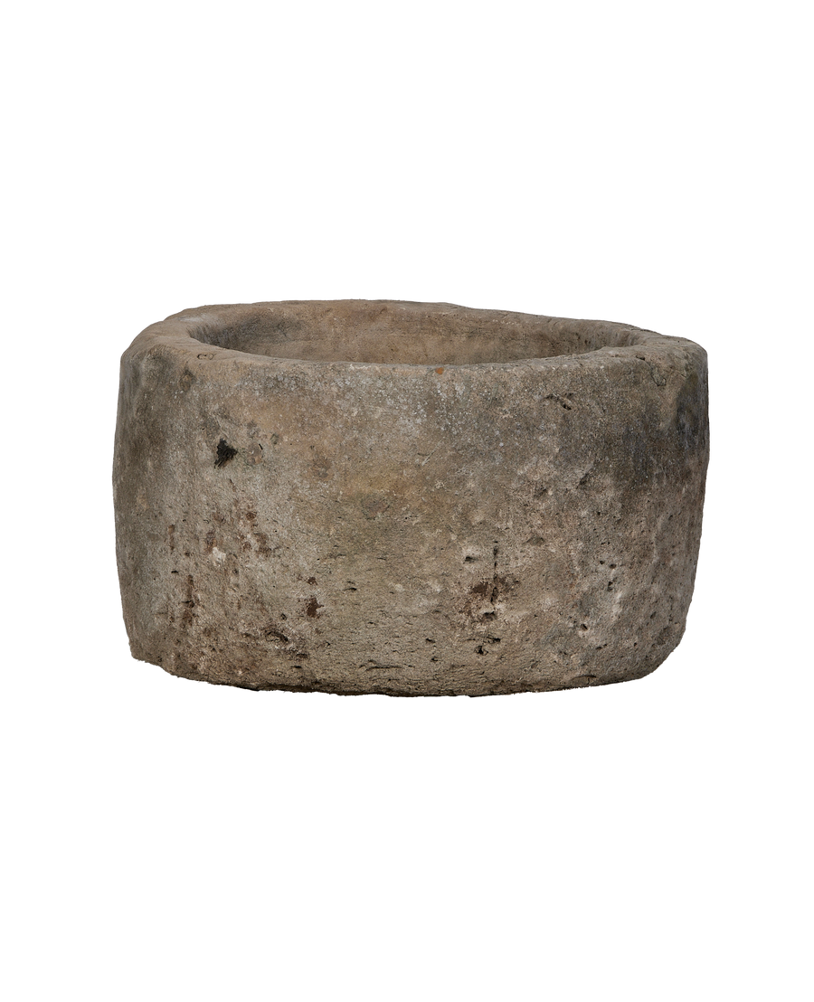 Vintage Indonesian round limestone trough, showing weathered texture and natural imperfections.