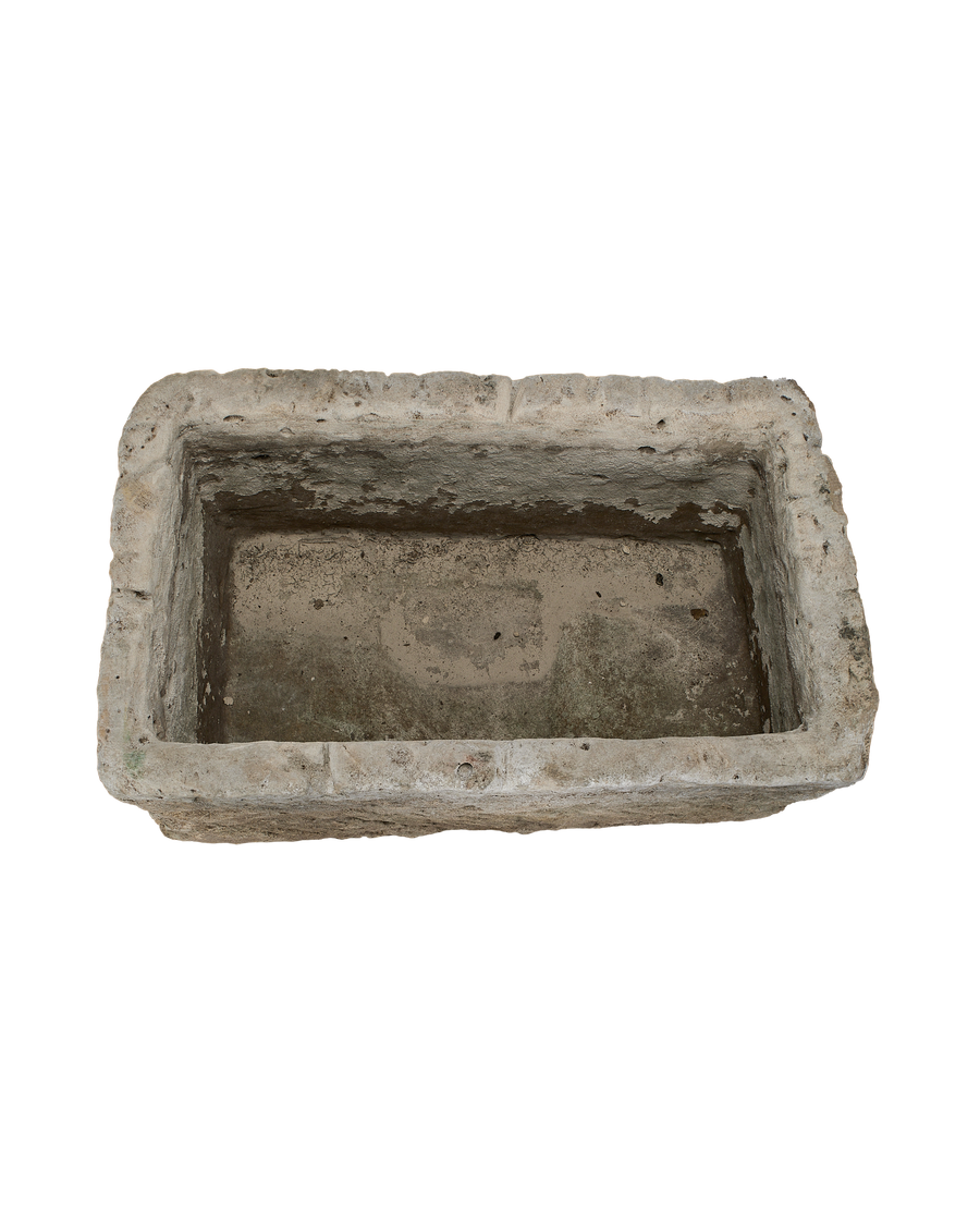 Vintage Indonesian limestone trough, top-down view showing interior depth and rough texture.