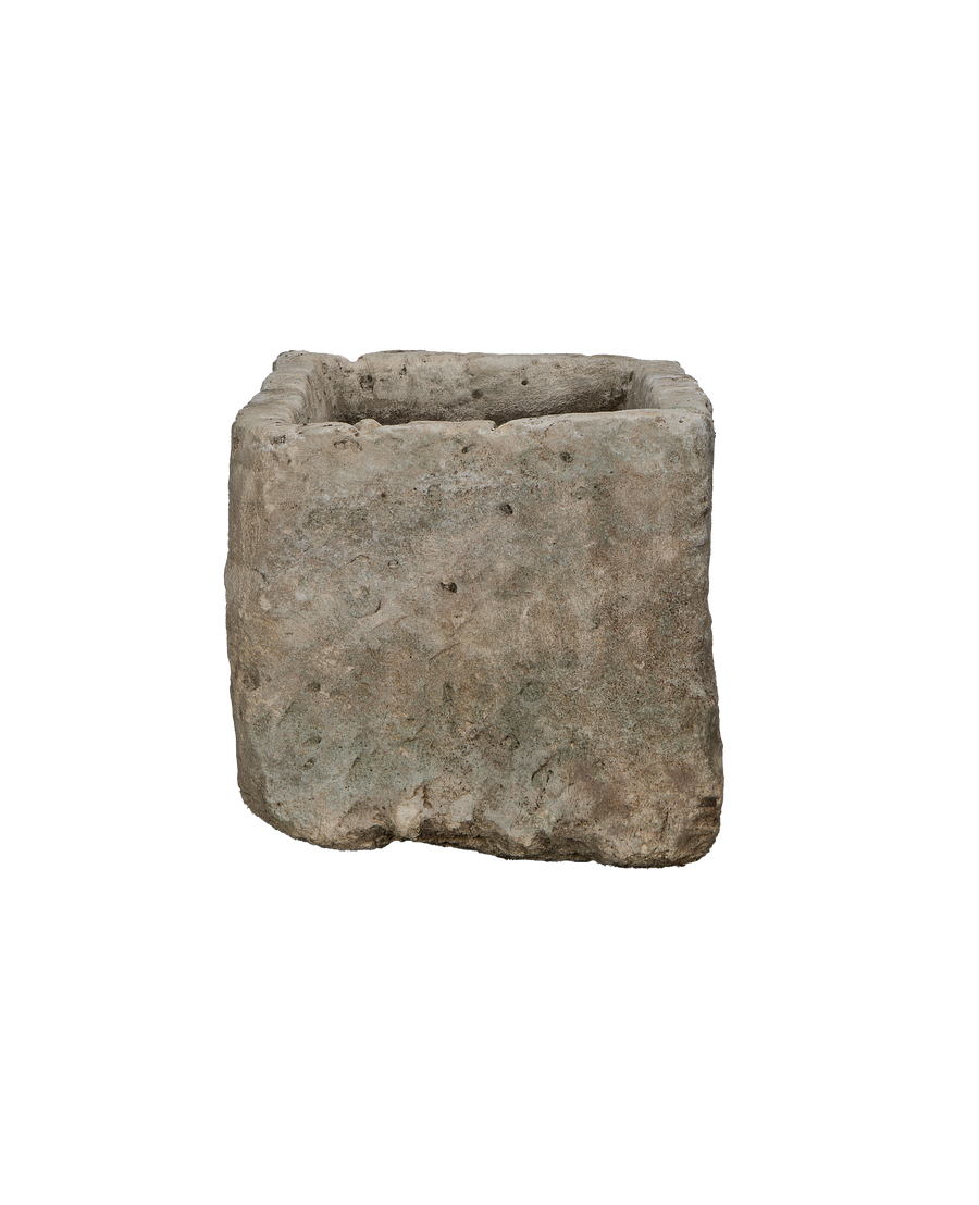 Vintage Indonesian limestone trough viewed from an unadorned, textured side, highlighting natural wear.