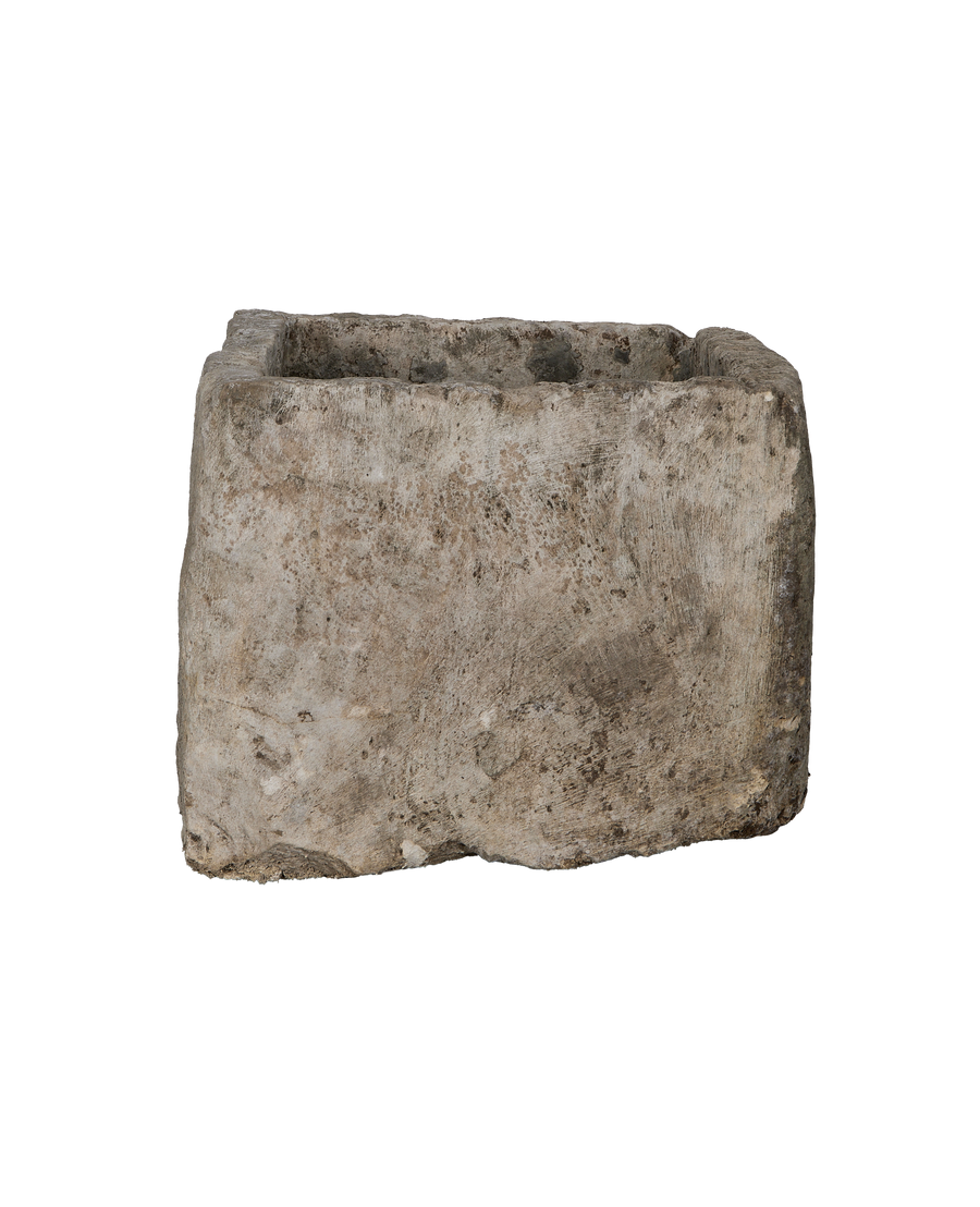 Vintage rectangular limestone trough, showing rough-hewn front texture and varied patinated surface.