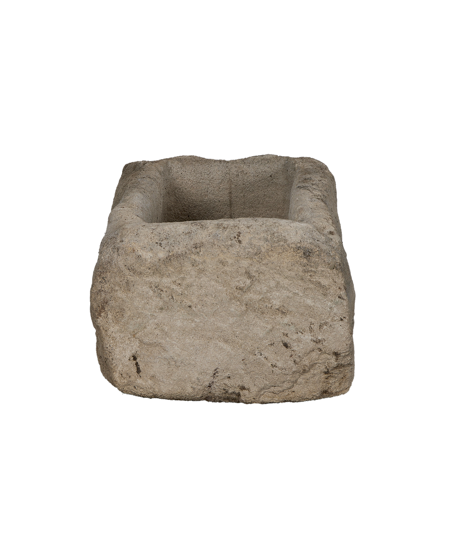 Vintage rectangular limestone trough, showing the rough textured exterior and carved interior.