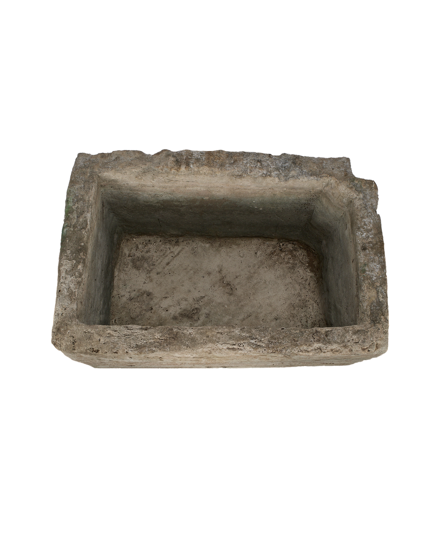 Vintage rectangular limestone trough, showing the weathered texture and rough-hewn interior from a top-down angle.