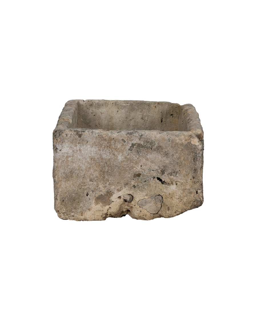 Vintage rectangular limestone trough, showing a side view with natural rough texture and weathered patina.