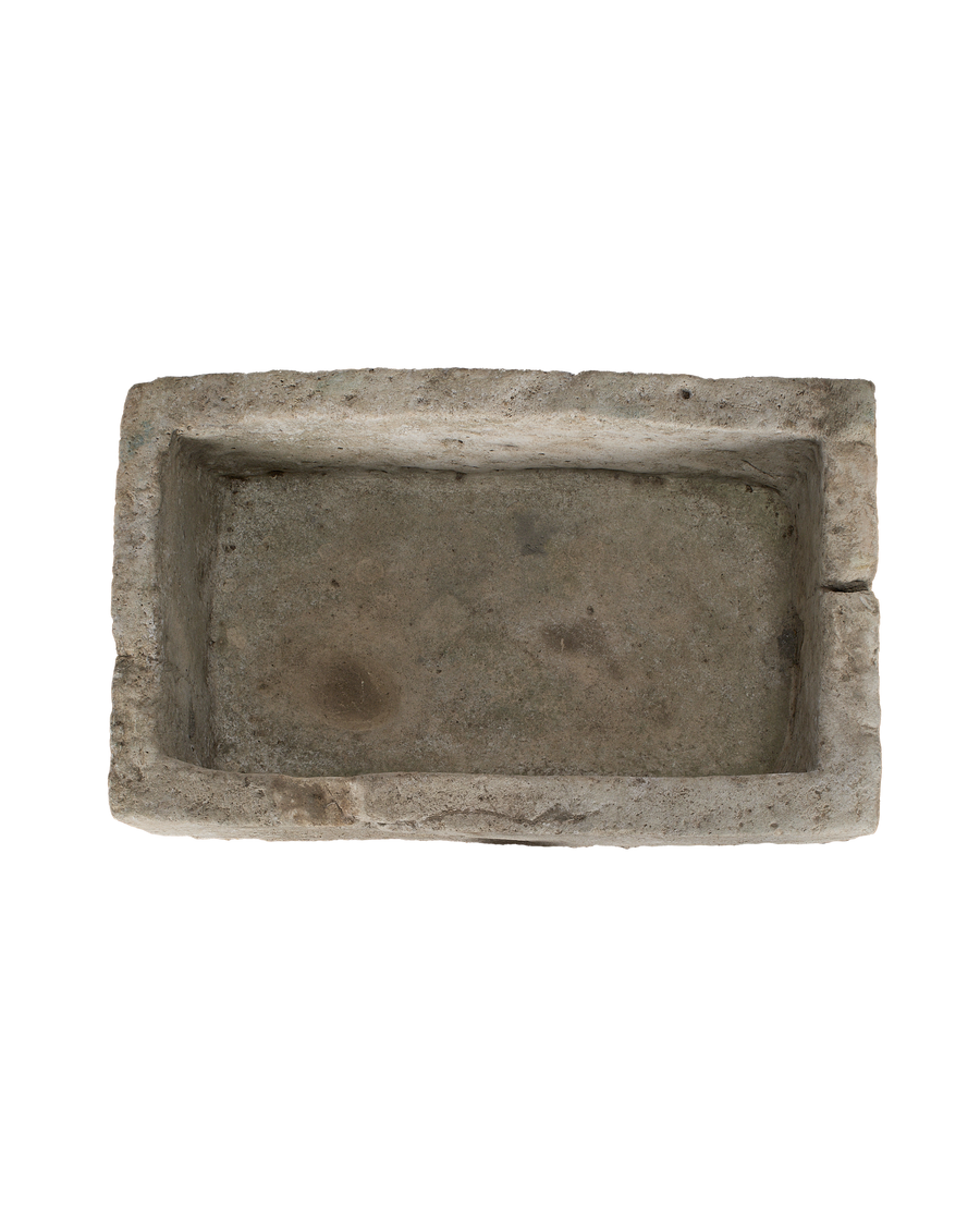 Vintage Indonesian limestone trough closeup, featuring rough-hewn rectangular edges and weathered interior.