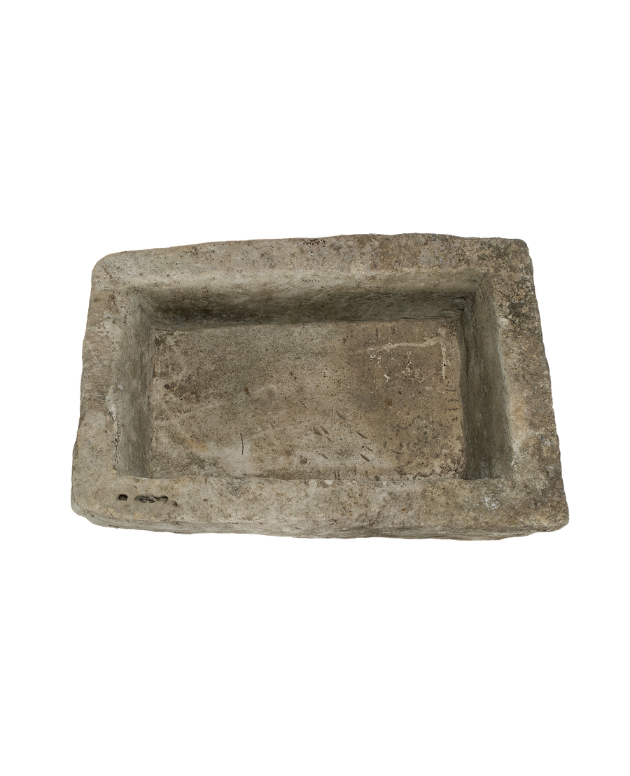 Vintage Indonesian limestone trough viewed from top, highlighting rustic texture and original drainage holes.