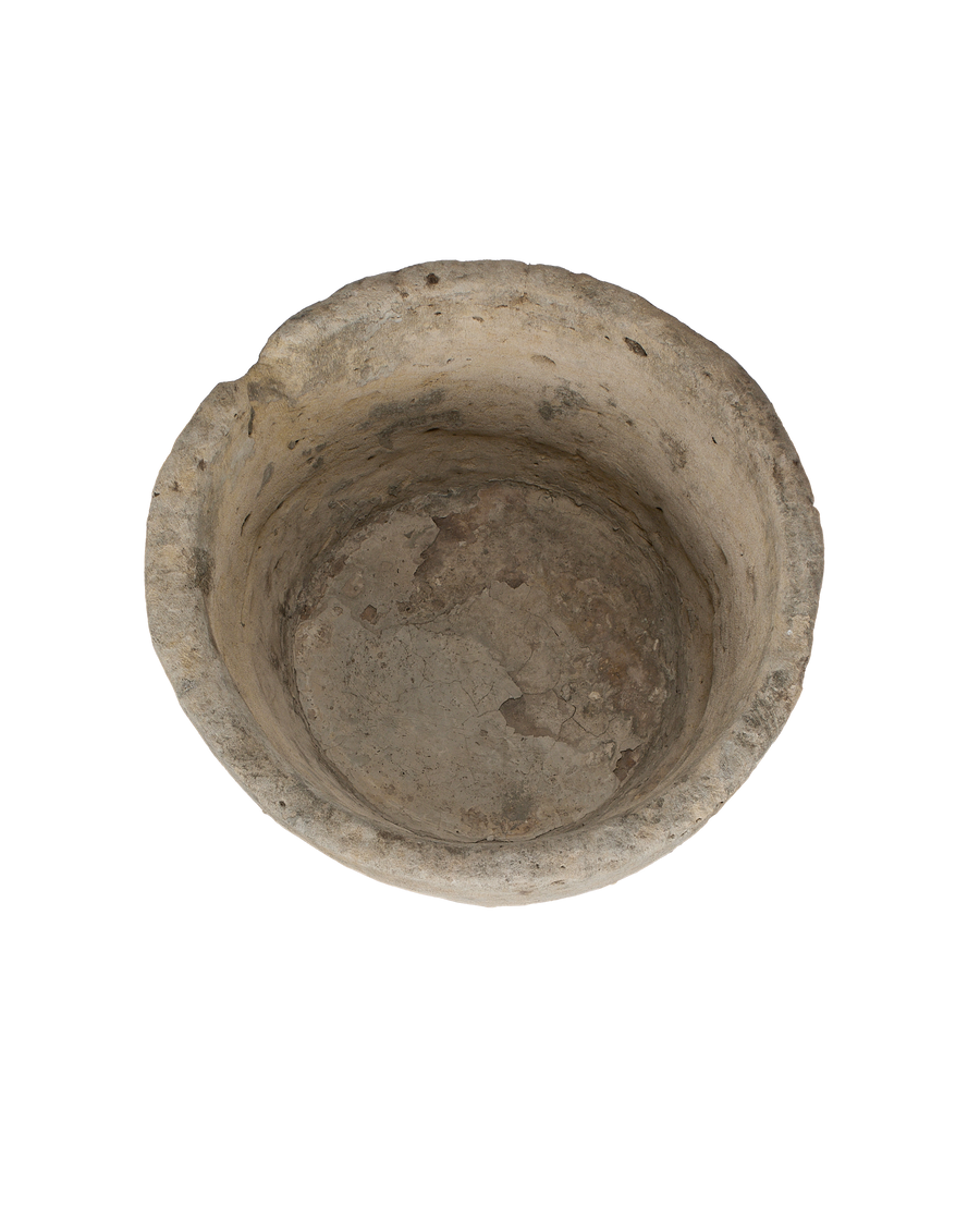 Vintage round Indonesian limestone trough, top view reveals aged interior and worn texture.