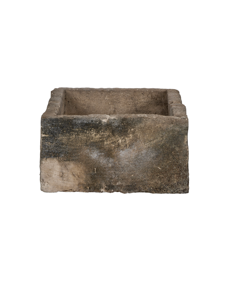 Vintage Indonesian rectangular limestone trough showing weathered, textured surface and top edge.