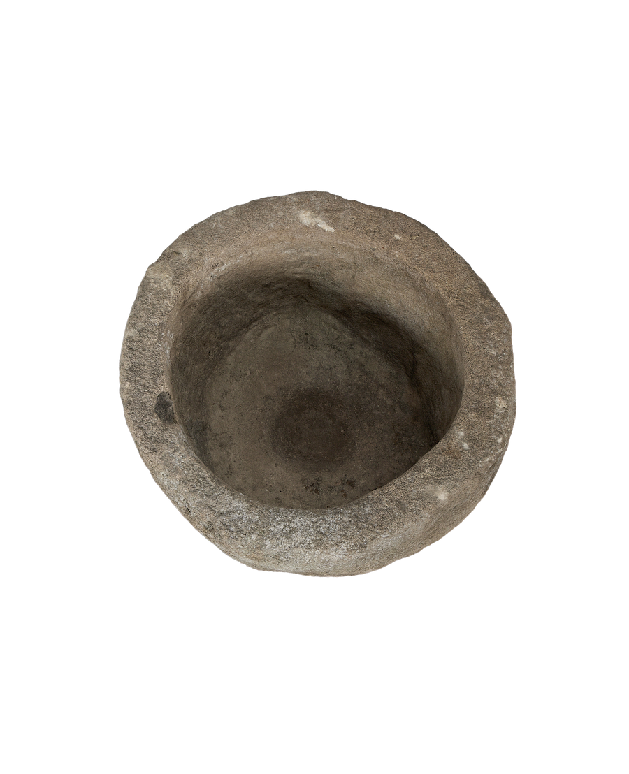 Vintage Indonesian limestone trough, close-up angled interior view, rustic texture, natural wear and patina.