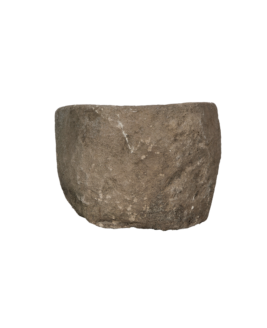 Vintage Indonesian limestone trough, close-up texture details of the rugged exterior.