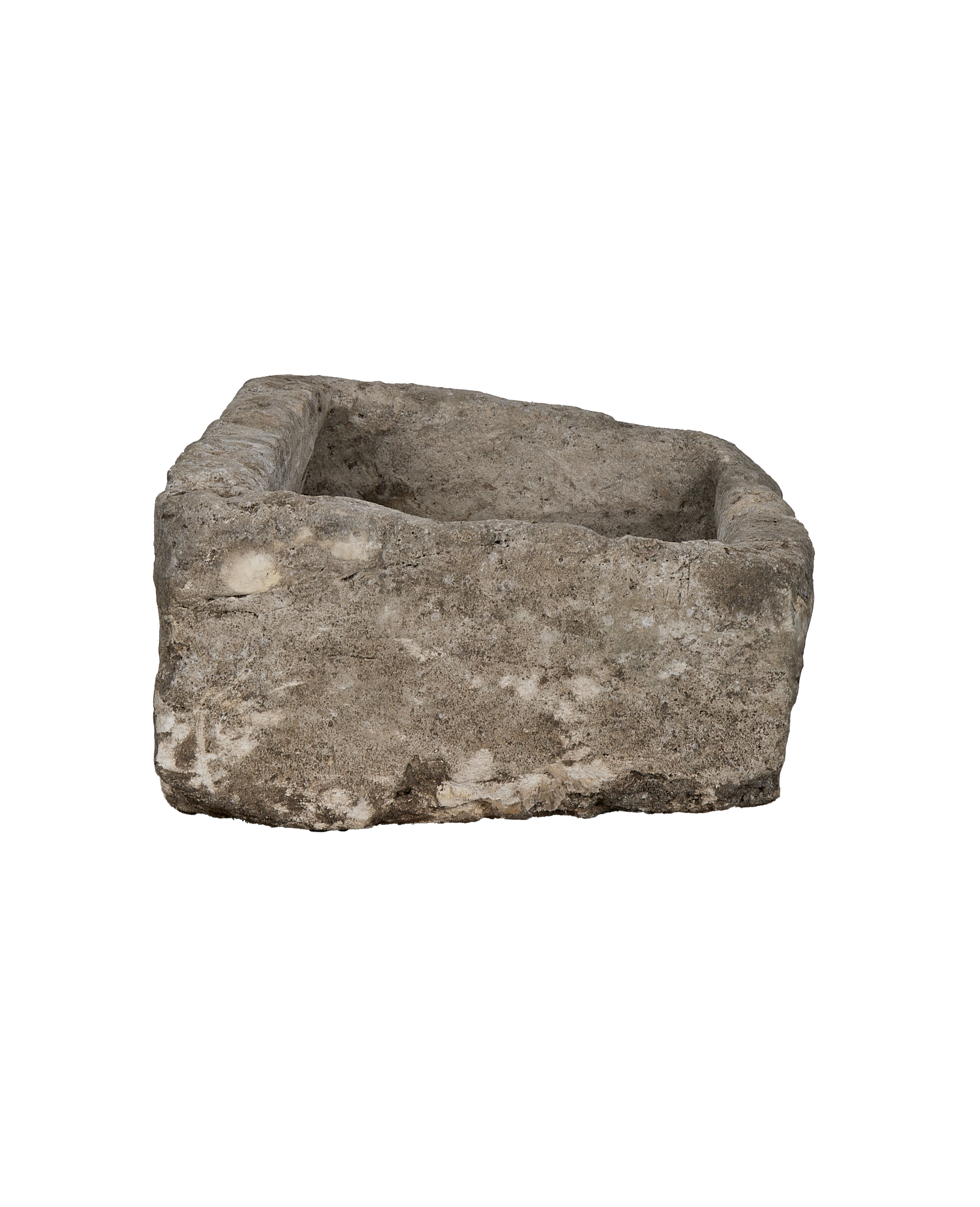 Vintage rectangular limestone trough, low-angle view showcasing textured, weathered surface imperfections.