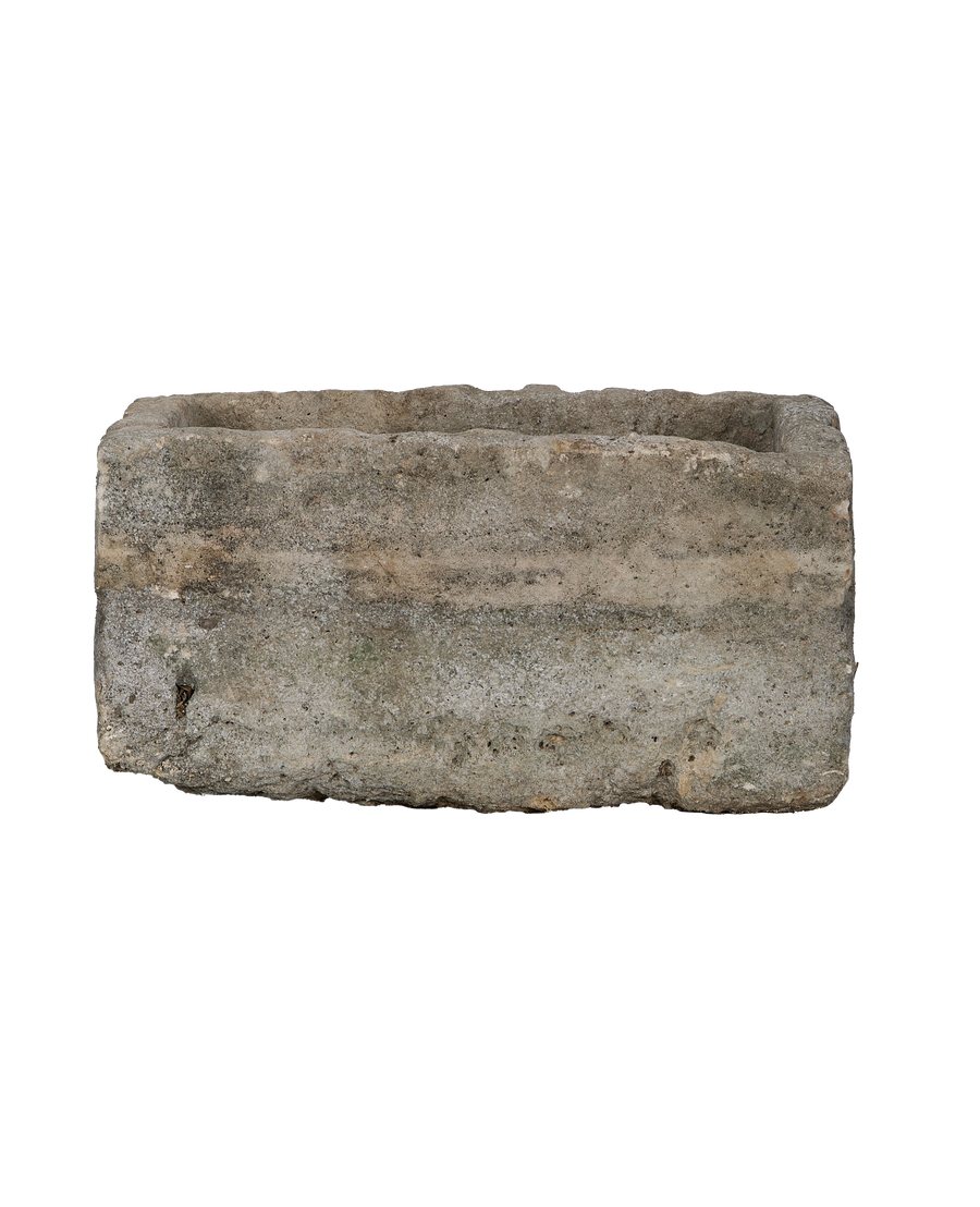 Vintage Indonesian limestone trough, rectangular, revealing textured surface and rugged bottom edge.