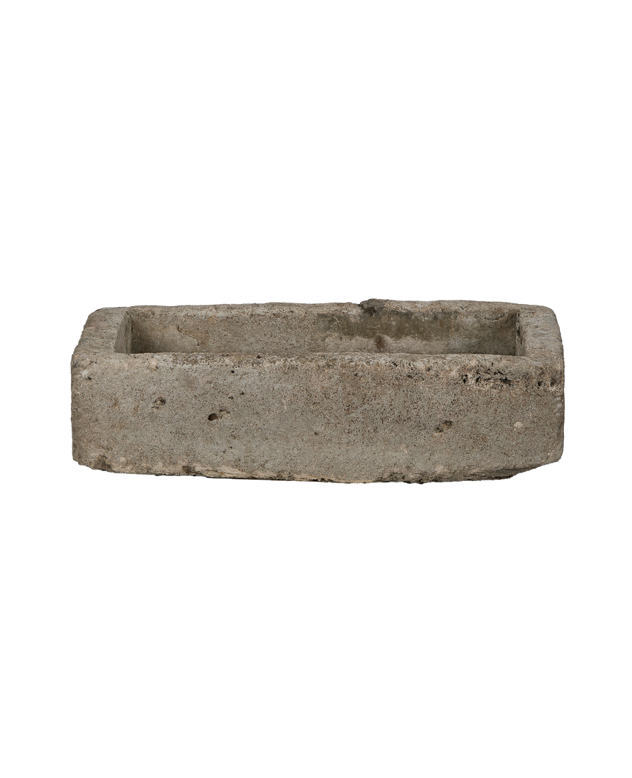 Vintage rectangular limestone trough, showing rough-hewn texture and aged surface.