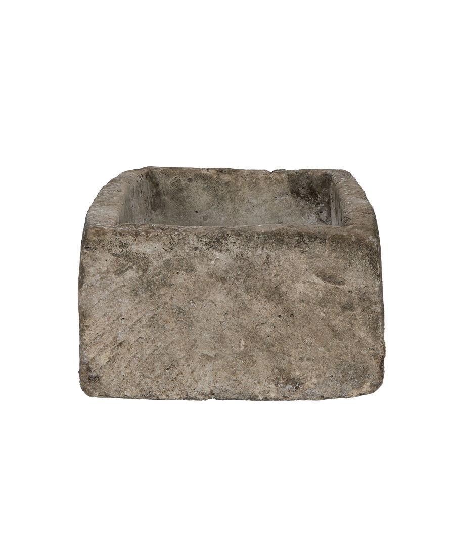 Vintage Indonesian limestone trough viewed from the front, showcasing weathered texture and rectangular shape.
