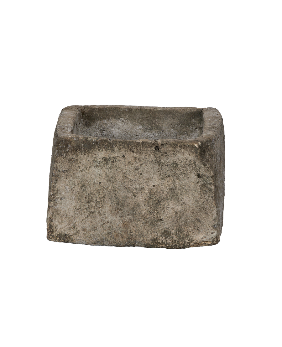 Vintage Indonesian limestone trough, OAK, showing rough weathered texture from side angle.