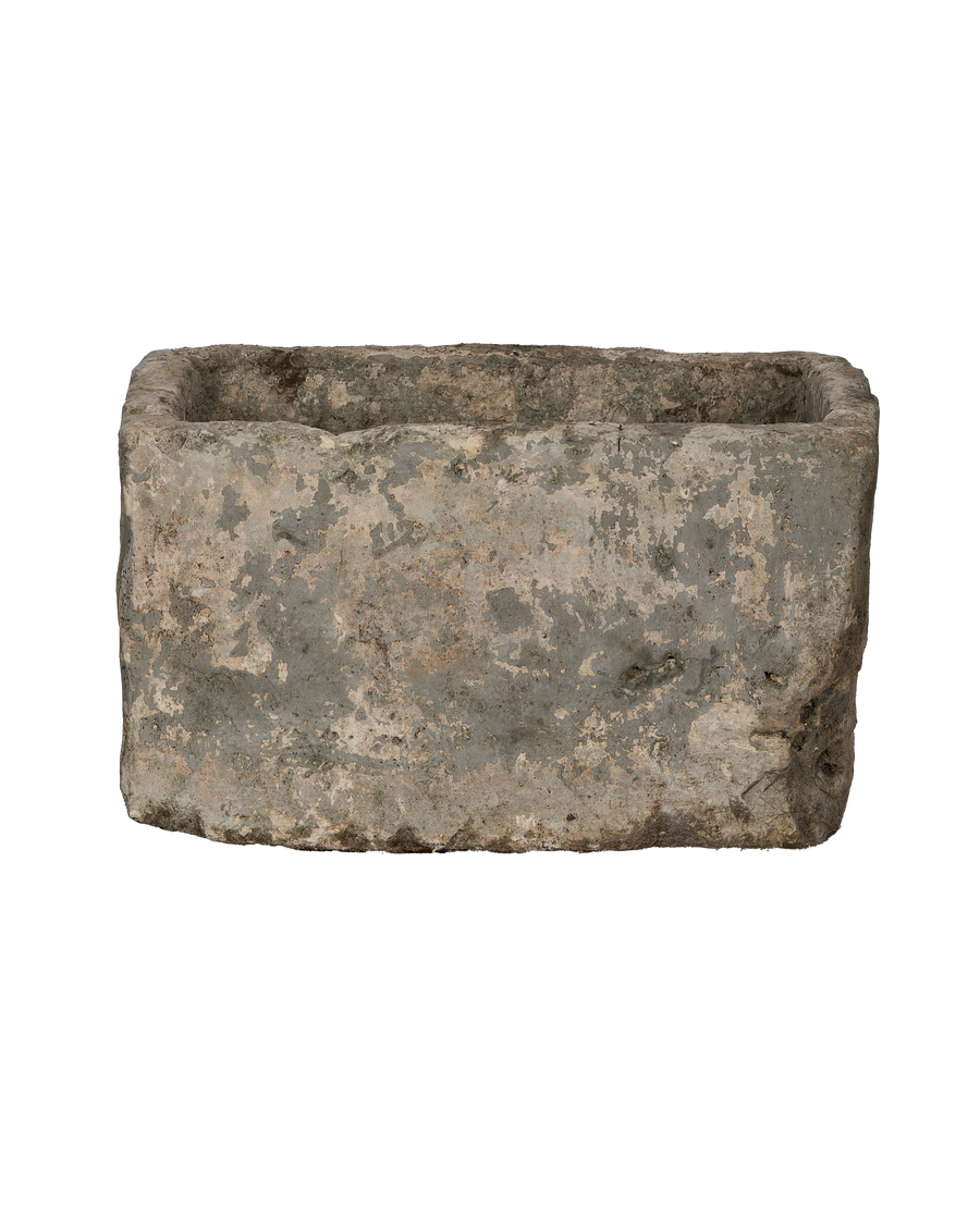 Vintage rectangular limestone trough, showing distressed weathered surface texture on side.