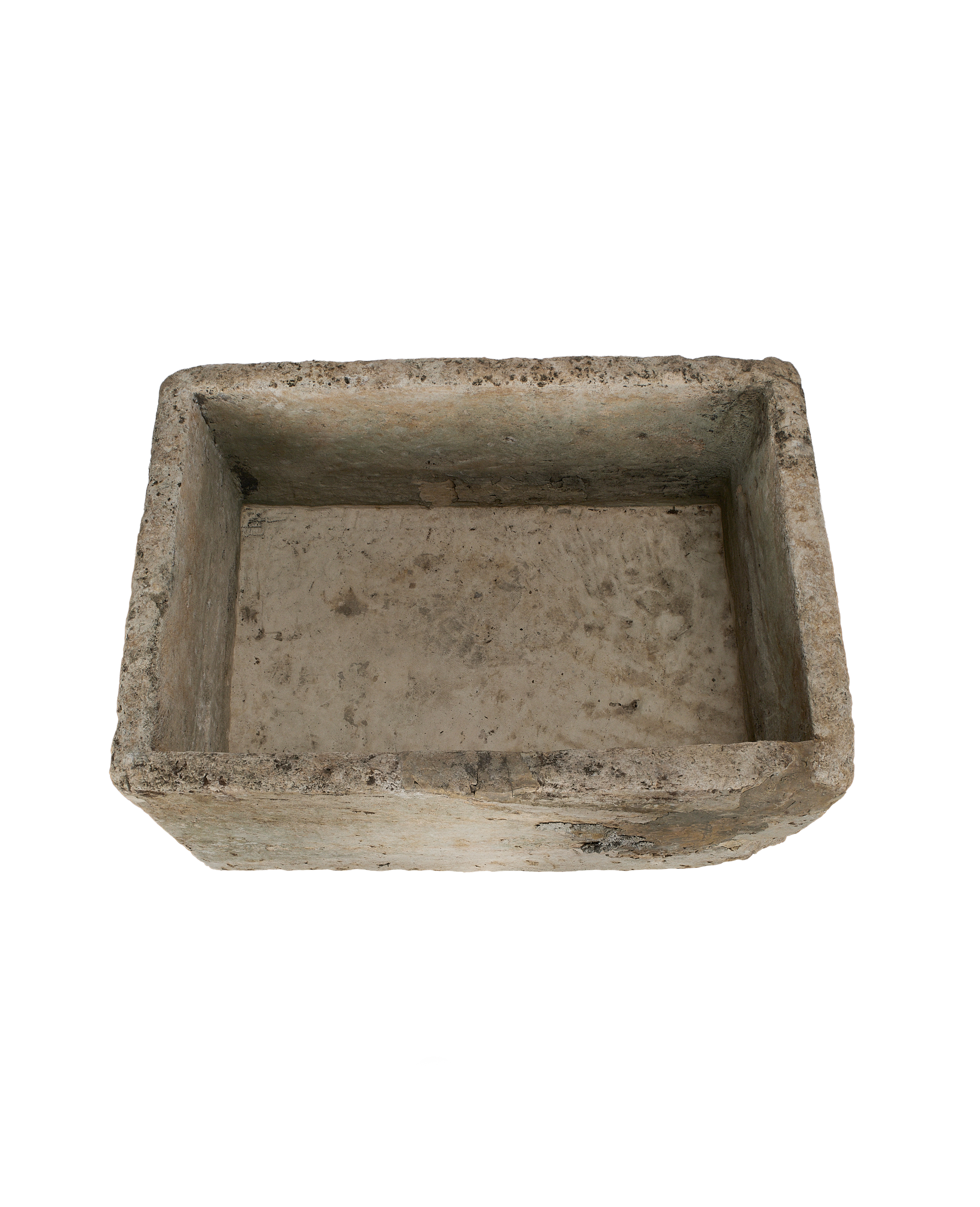 Vintage Indonesian limestone trough viewed from above, highlighting its weathered interior.