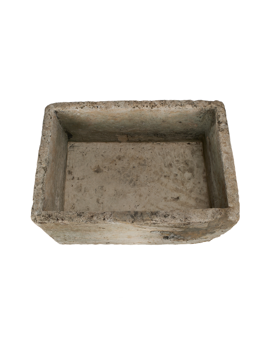 Vintage Indonesian limestone trough viewed from above, highlighting its weathered interior.