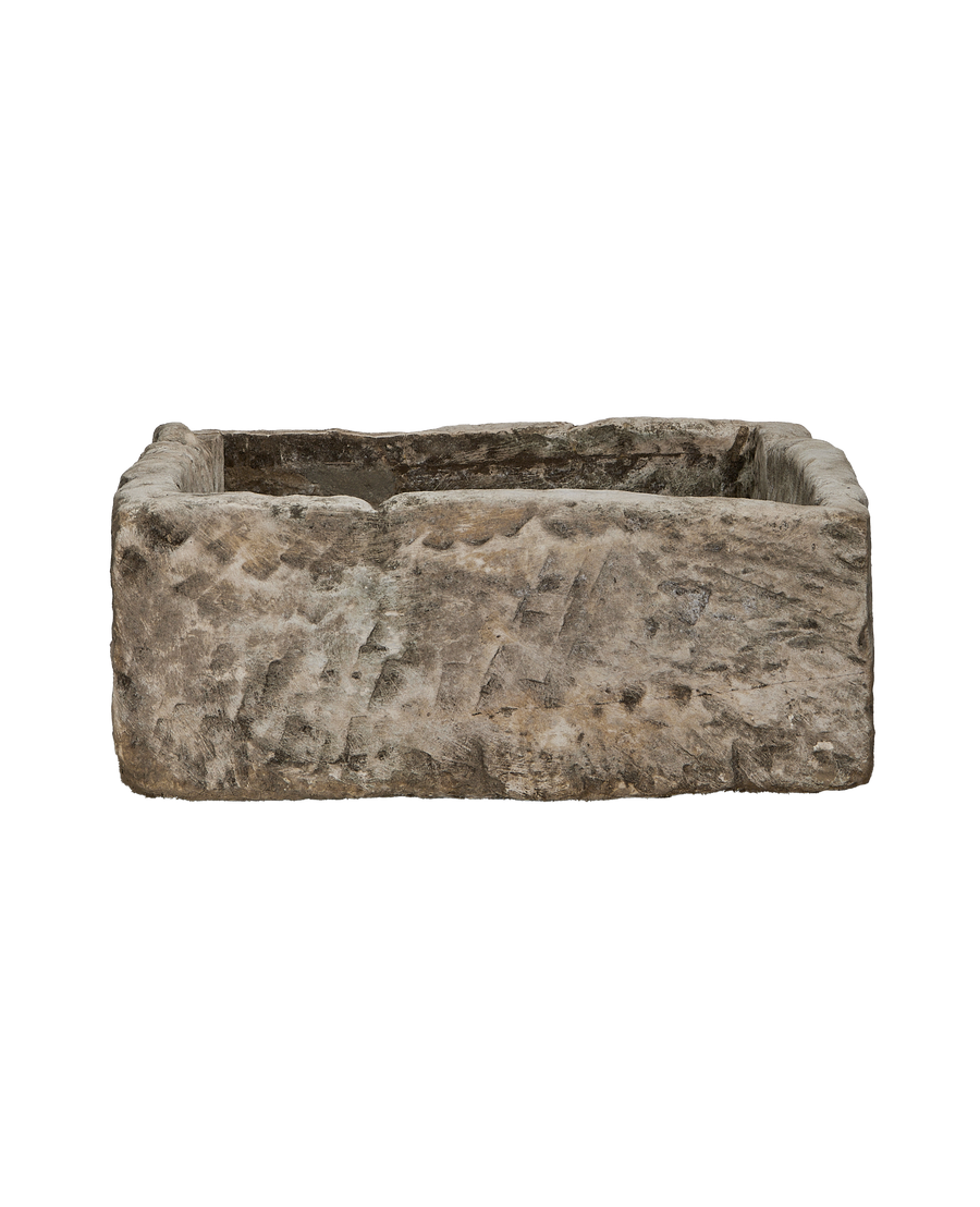 Vintage Indonesian rectangular limestone trough showing rough-hewn exterior texture and detail.