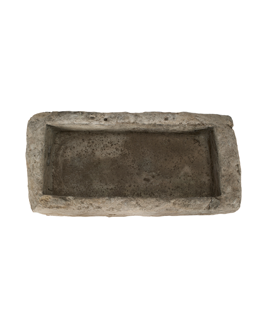 Vintage rectangular limestone trough, top view with distressed texture and aged patination.