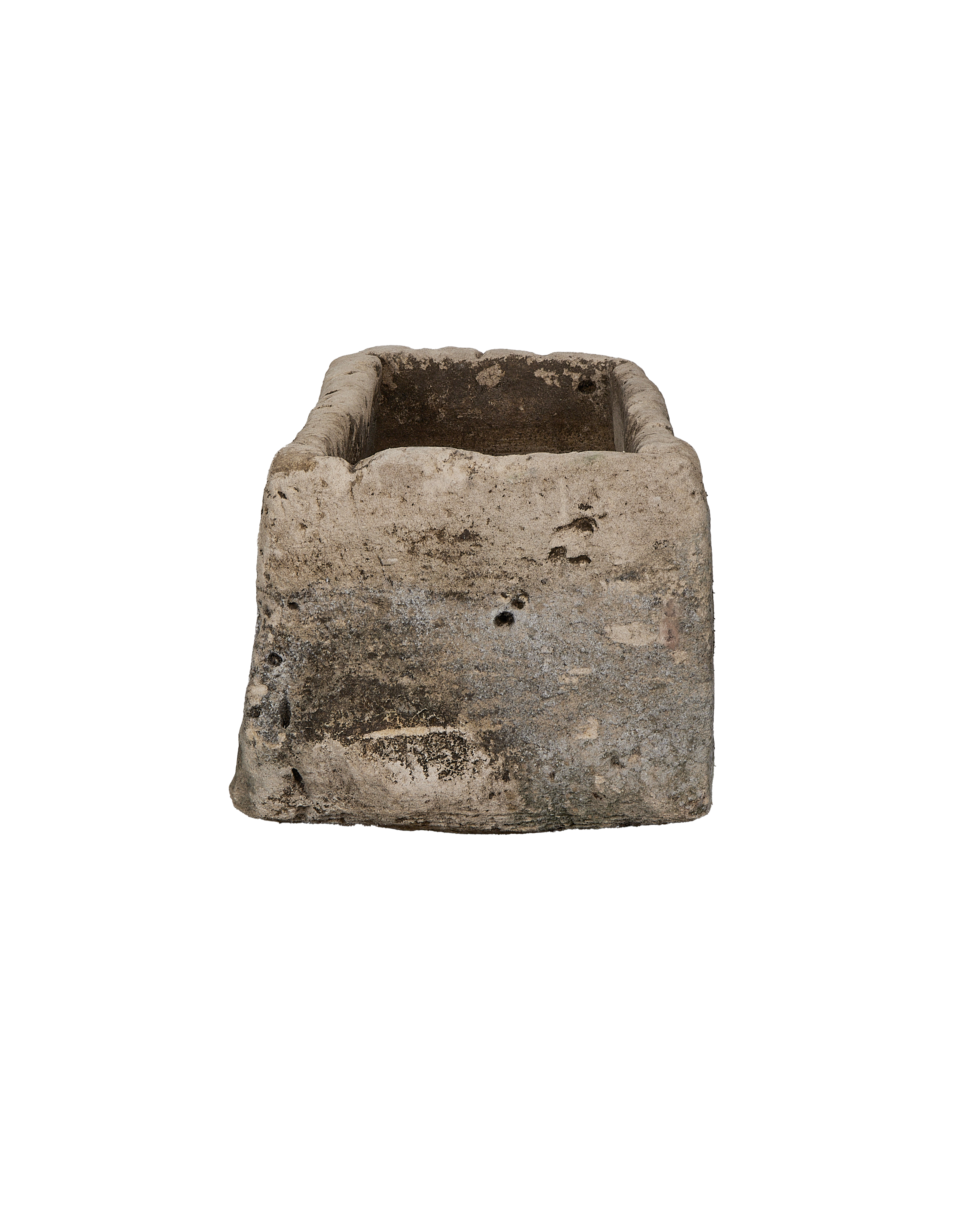 Vintage Indonesian limestone trough viewed from an angle, showcasing weathering and interior depth.