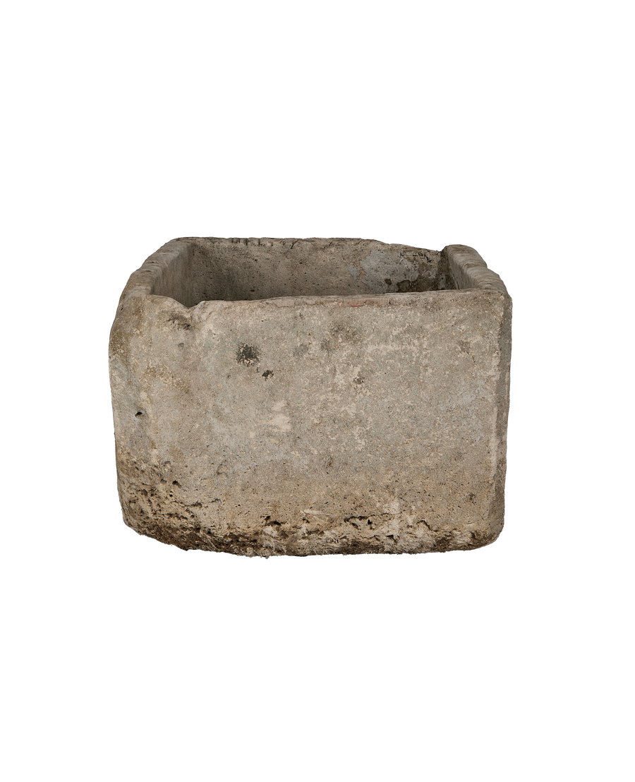 Rectangle vintage limestone trough side view, showing weathered, rough texture.