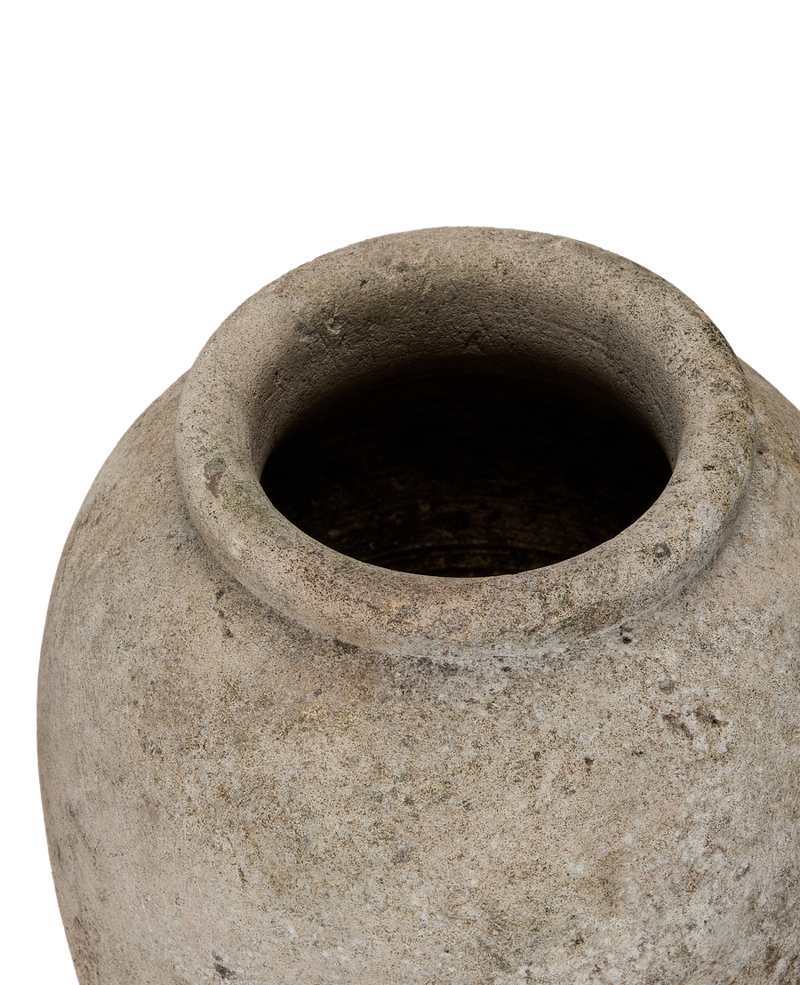 Vintage Indonesian stone vase, close-up of textured rim and weathered surface detail.