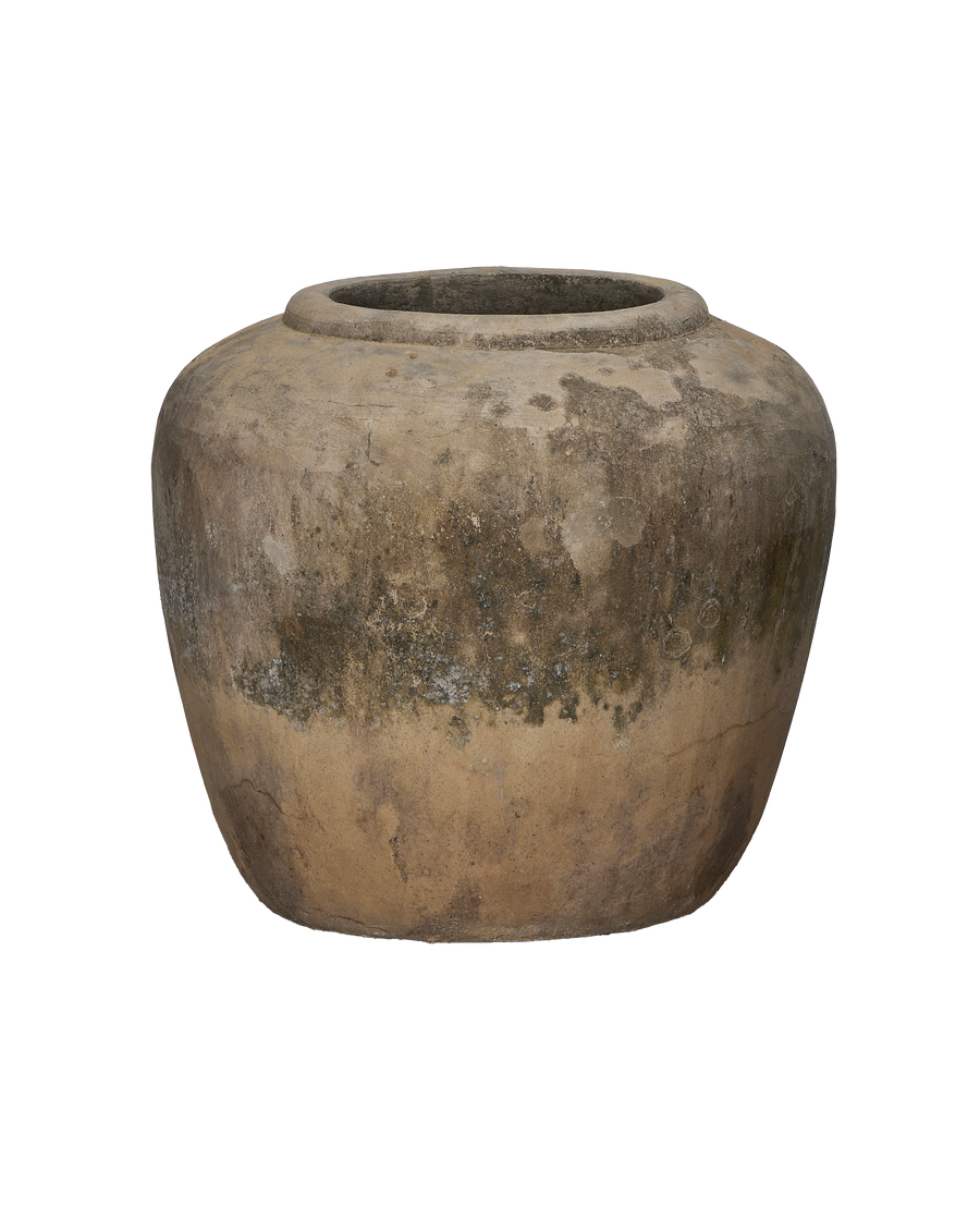 Vintage Indonesian stone pot, detailed view of mottled surface texture and rim.