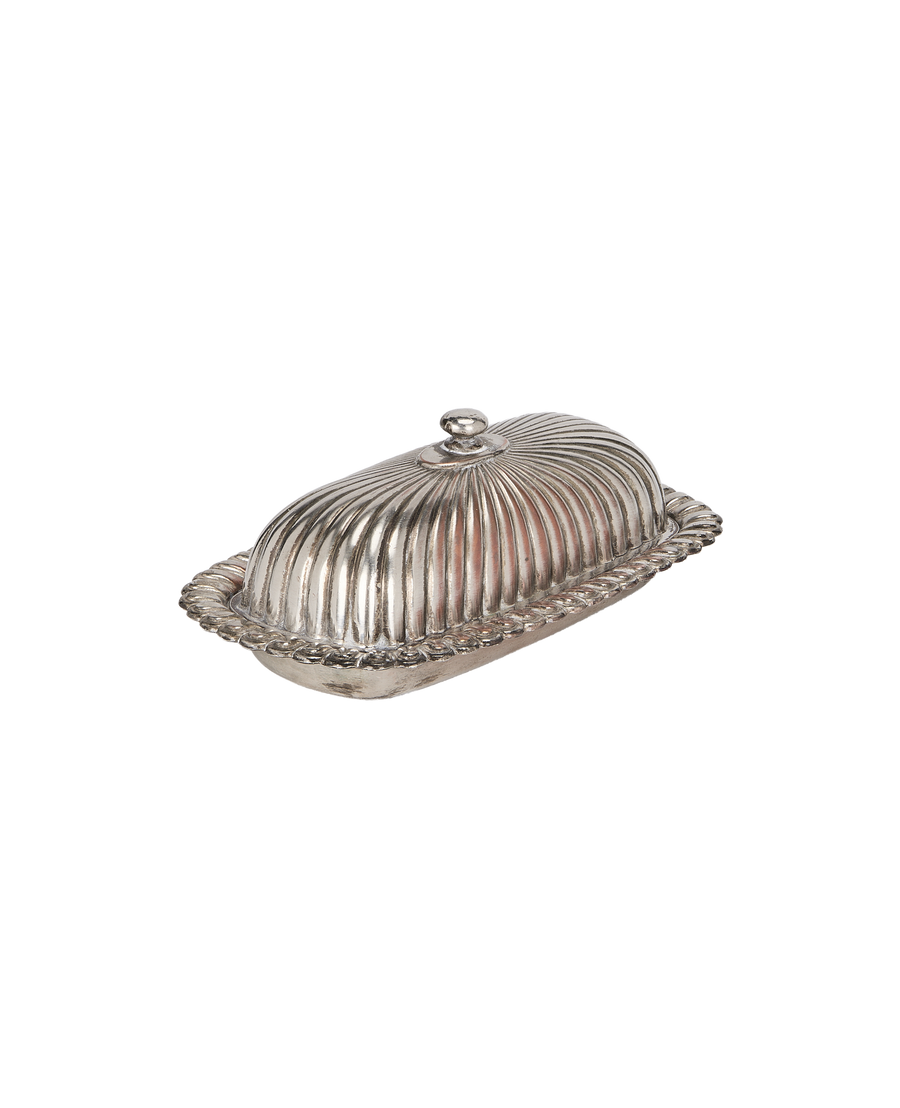 Vintage French corrugated silver butter dish from overhead, showcasing ornate rope trim.