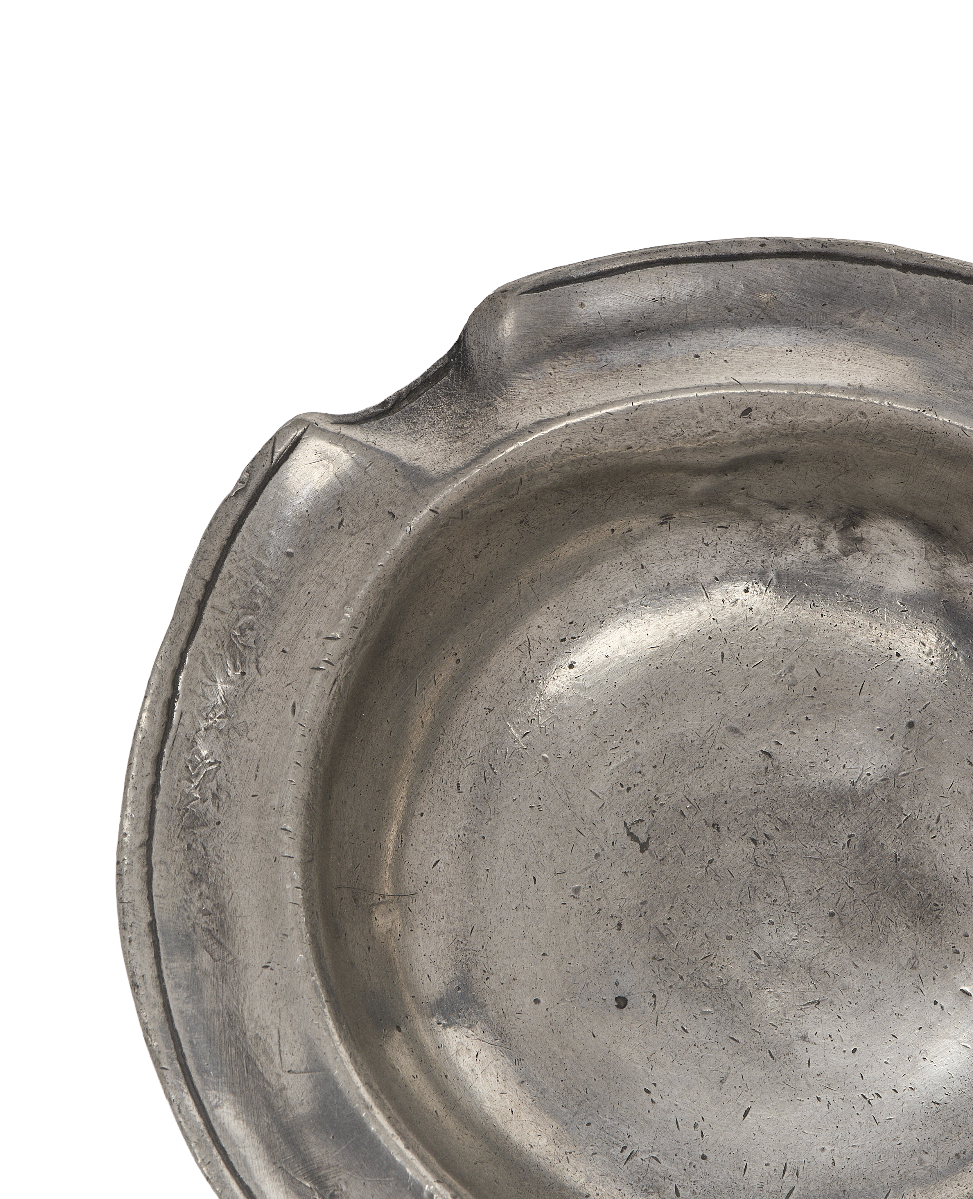 Vintage French pewter ashtray, close-up of intricate rim detail and worn metal texture.