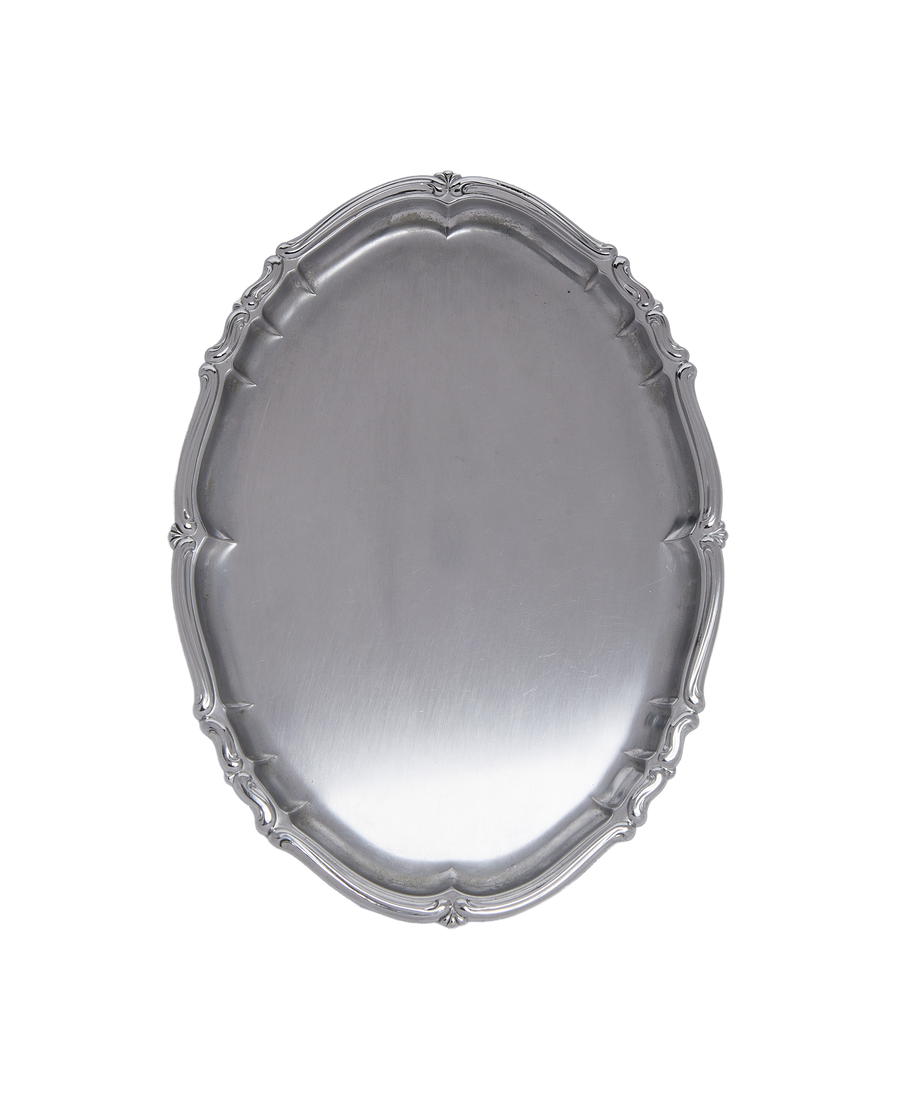 Vintage French metal serveware tray, showing full top view of ornate scalloped rim detail.
