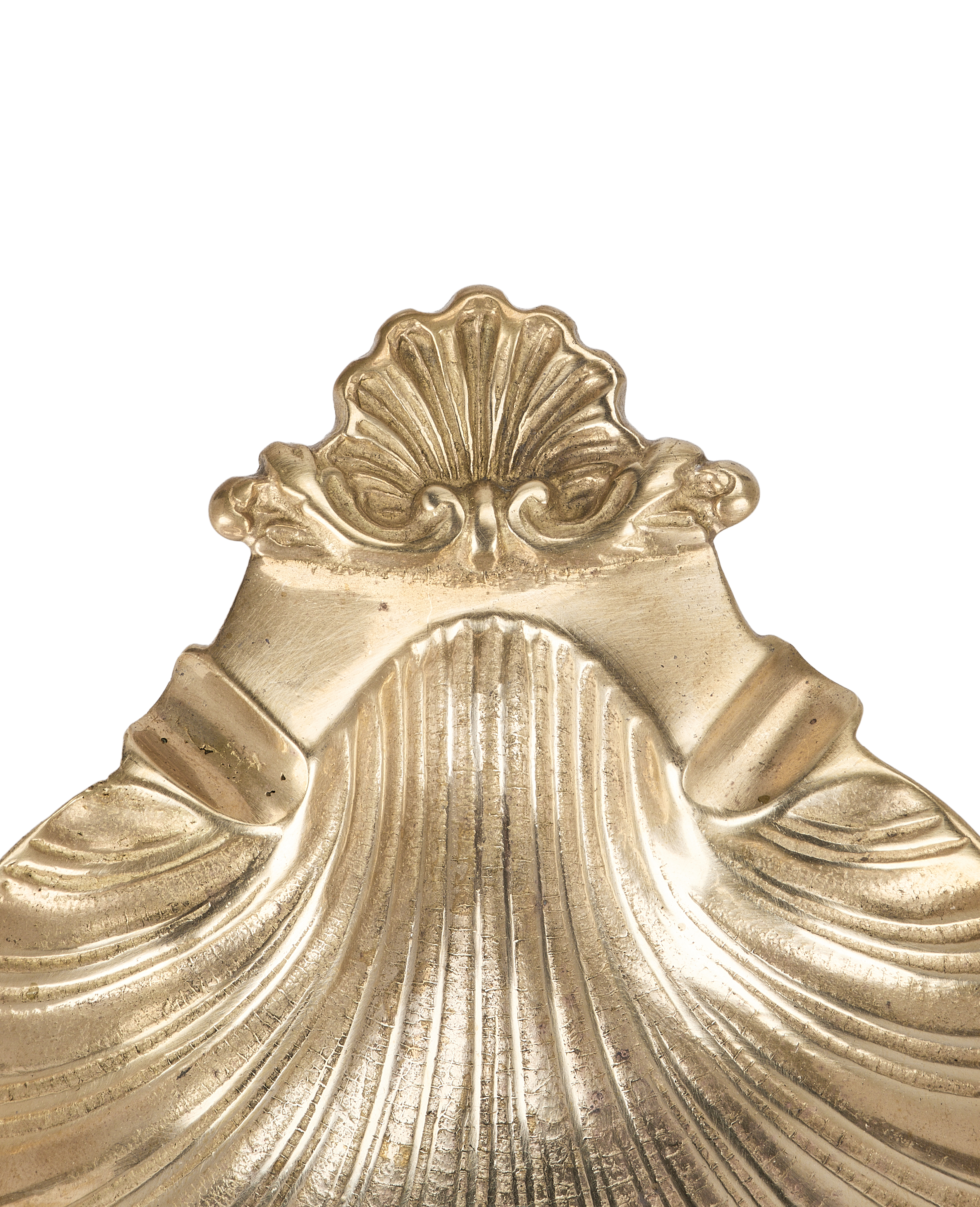Close-up of vintage French bronze shell vide poche's ornate scallop crest detail.