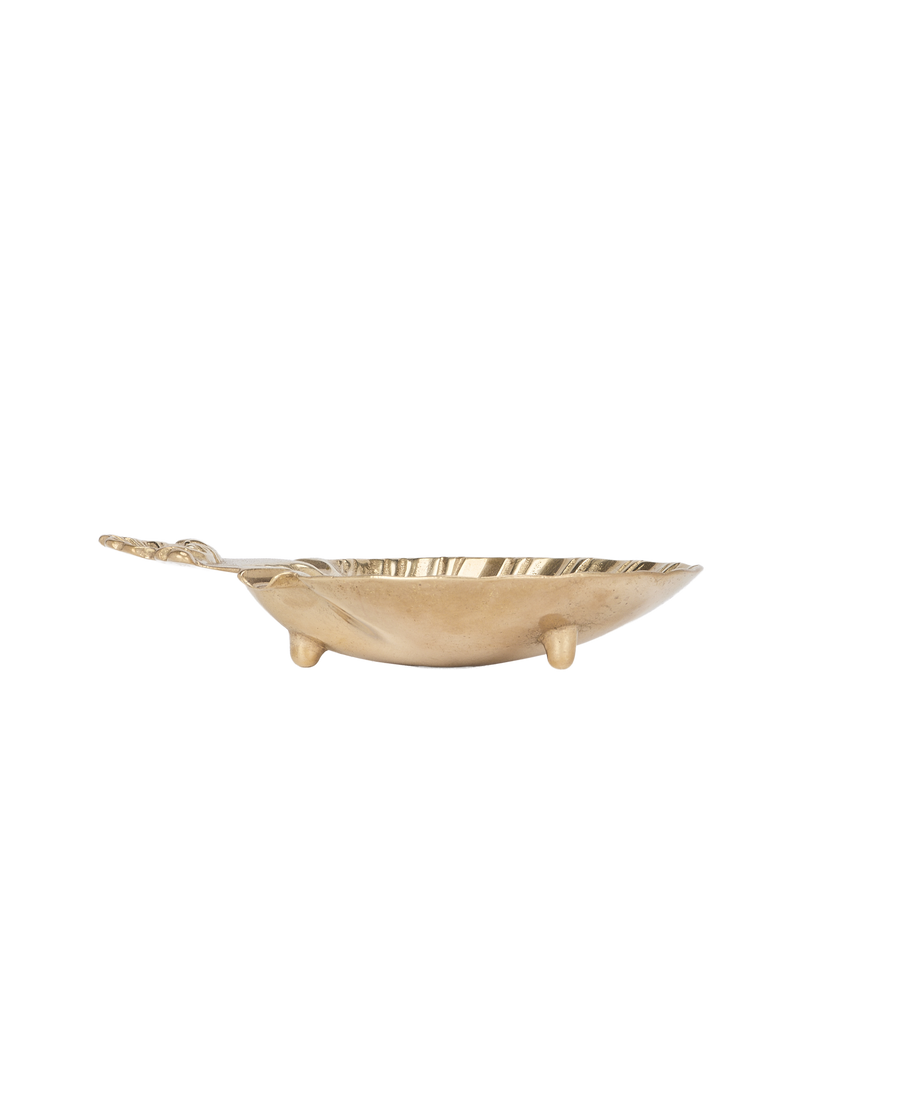 Vintage French brass shell vide poche, angled side view of three short legs.