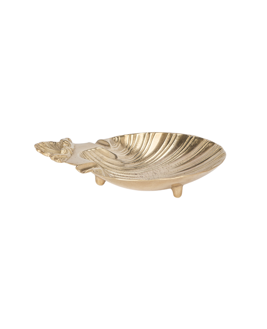 Vintage French brass shell vide poche, angled close-up revealing three sturdy feet.