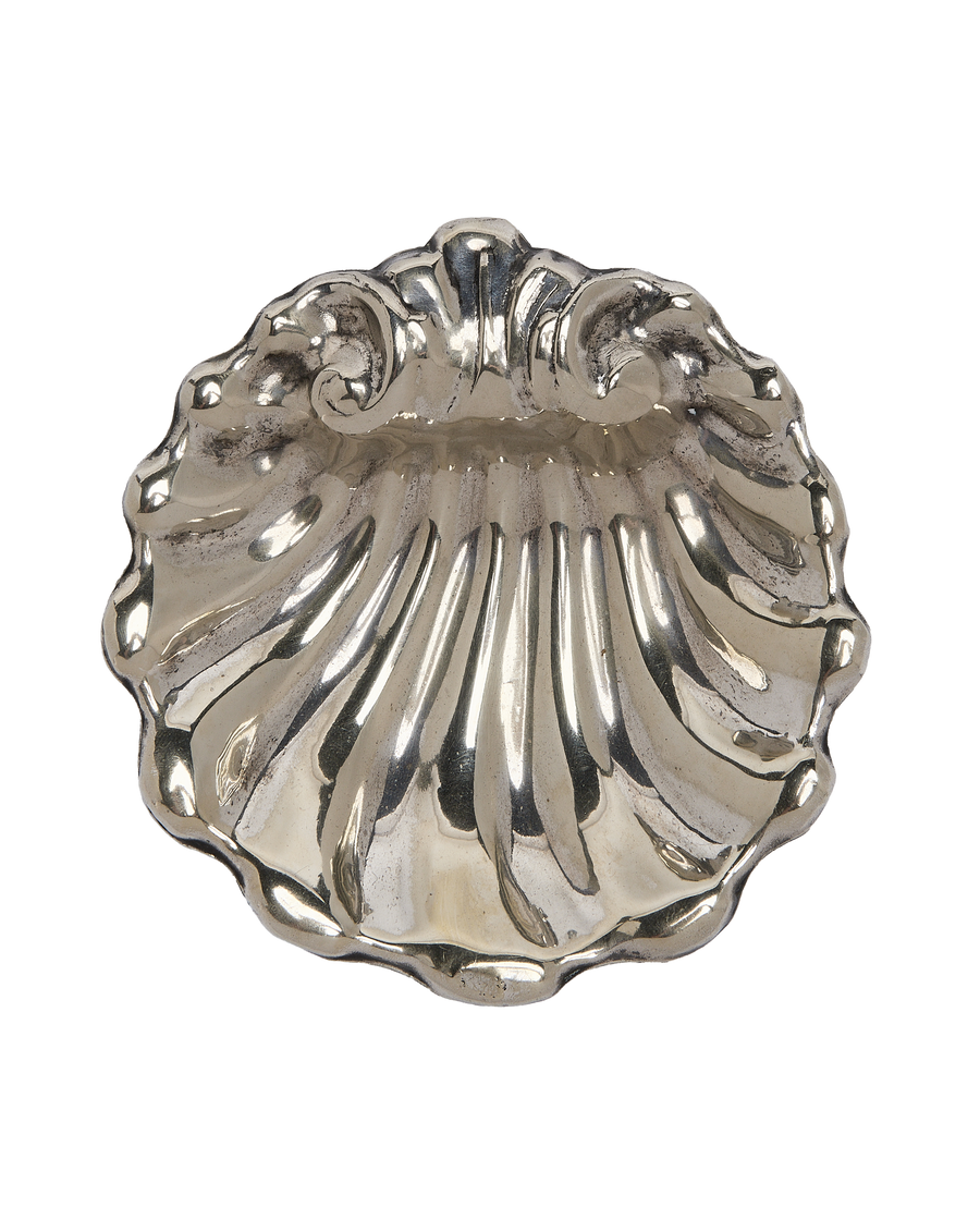 Vintage French silver plated vide poche, shell-shaped, showcasing aged patina and ornate detailing.
