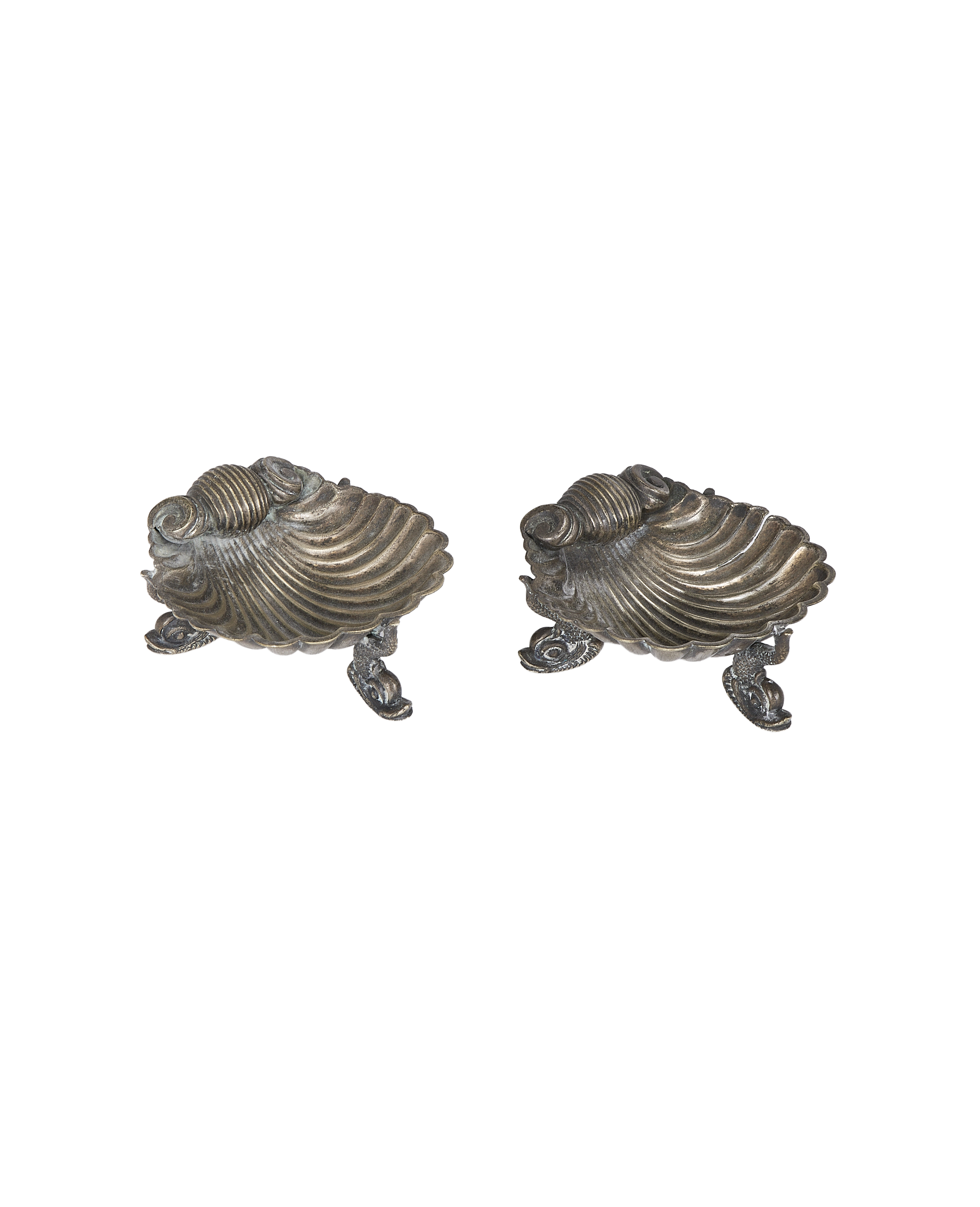 Vintage French brass shell ashtray set, showing detailed feet and aged patination.