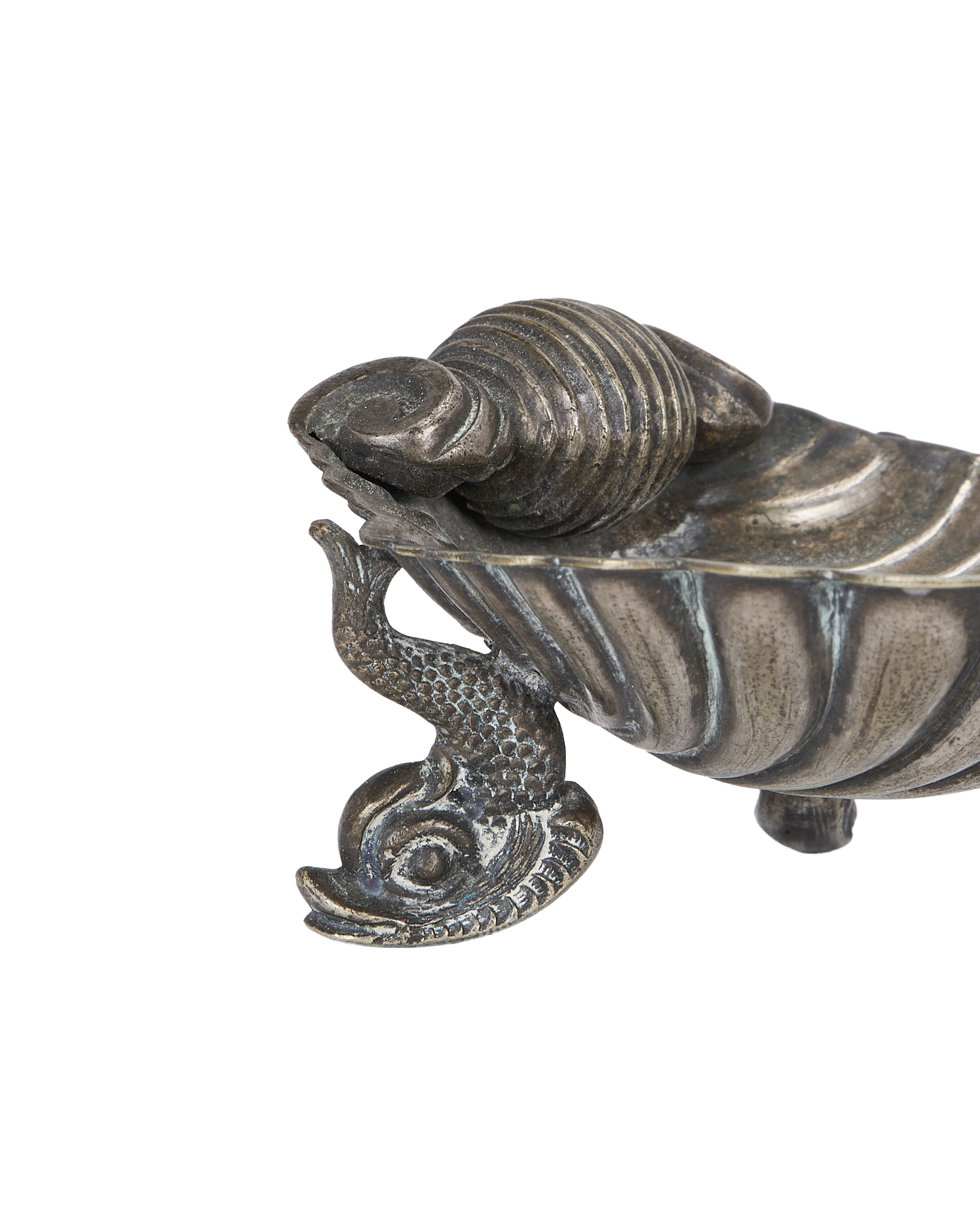 Close-up antique French brass shell ashtray showcasing aged patina and detailed dolphin feet.