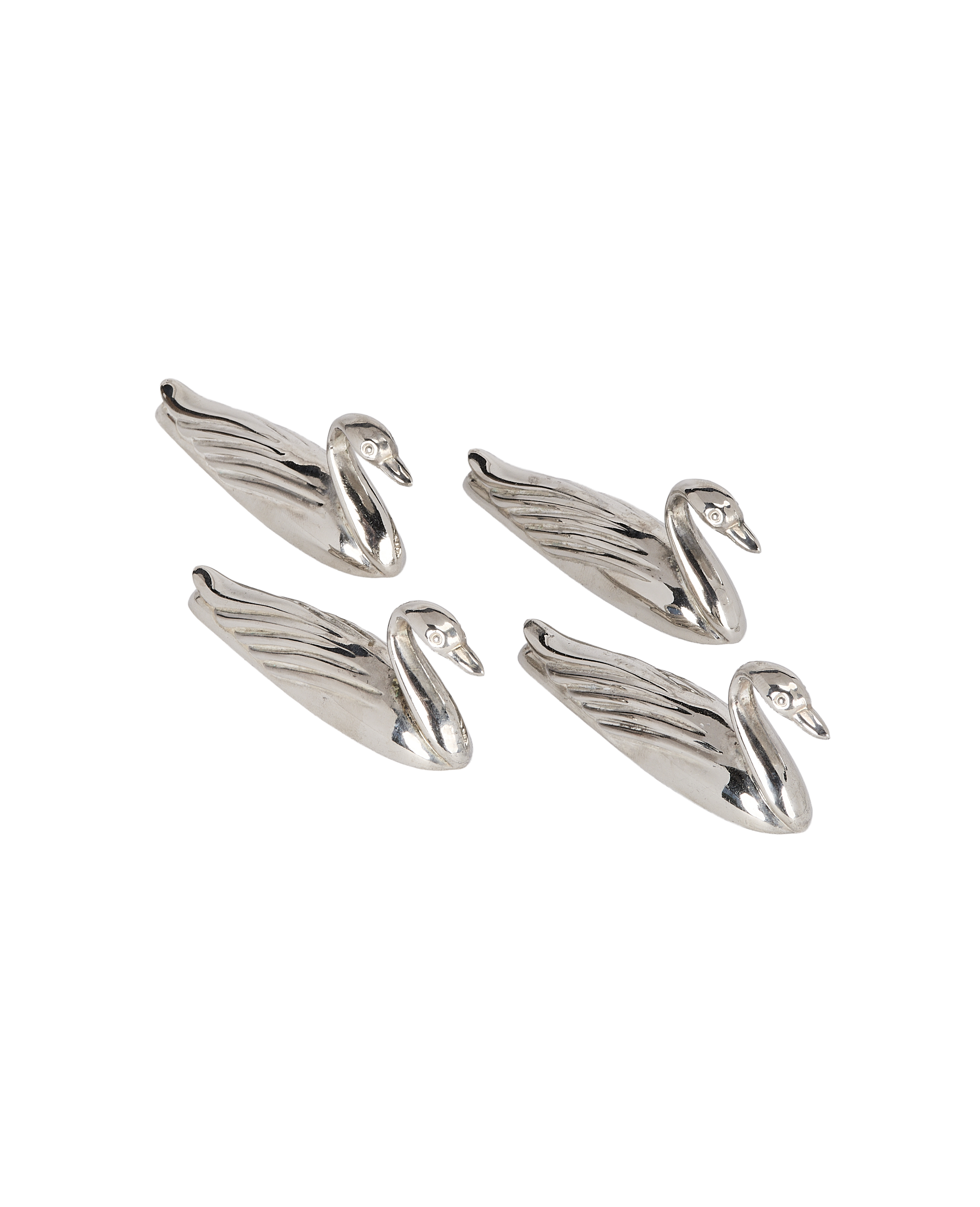 Four vintage French silver swan knife rests with detailed feathers.