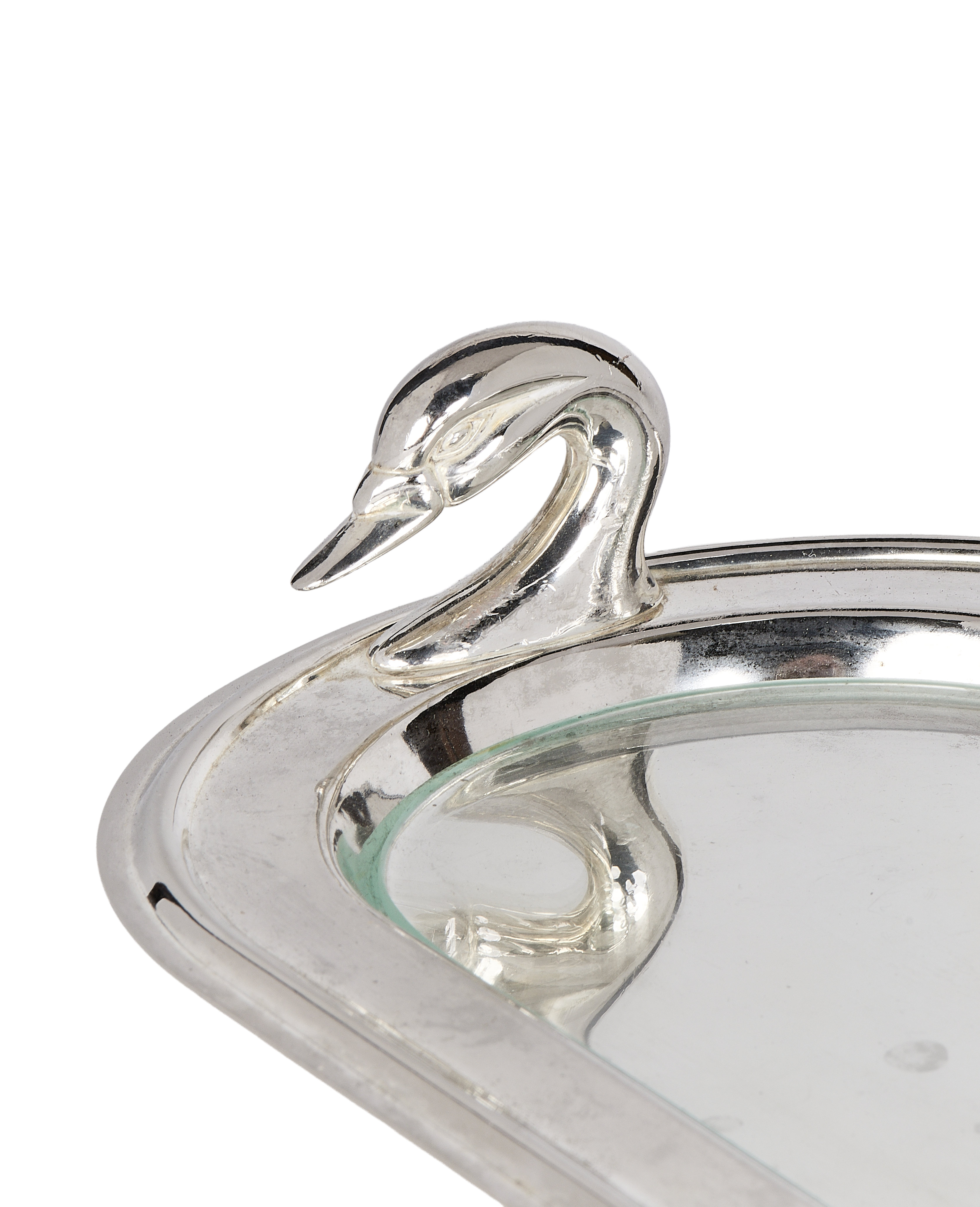 Close-up of vintage silver swan dish handle, showcasing detailed head and neck.