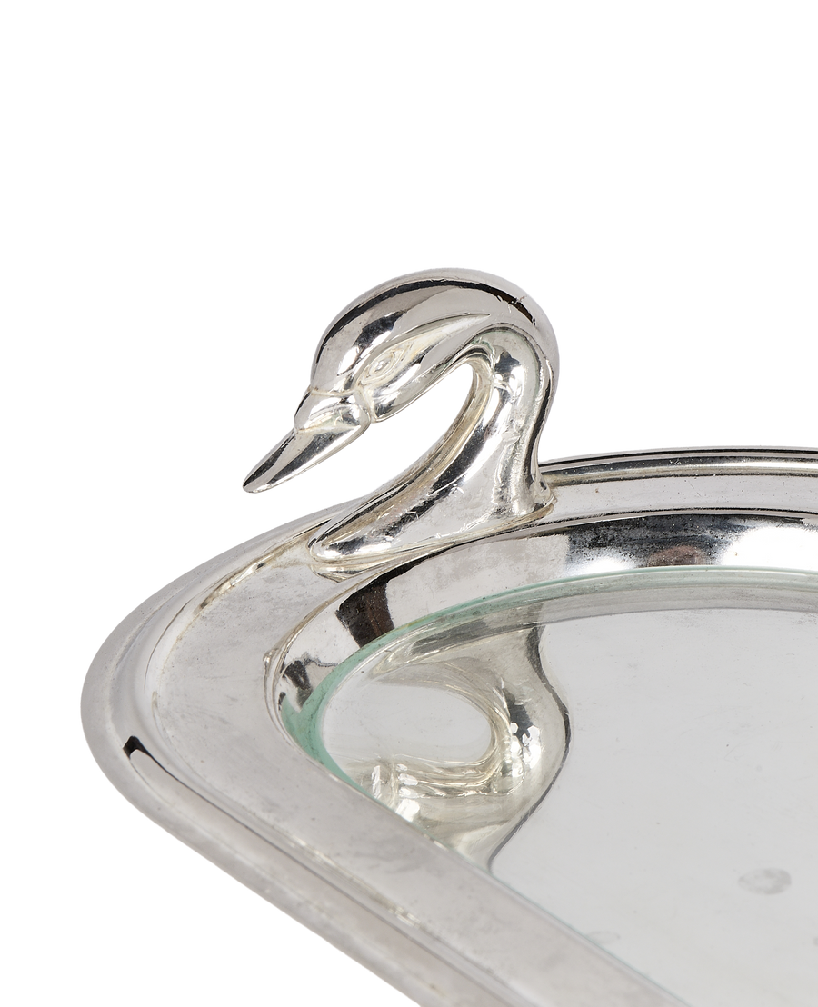 Close-up of vintage silver swan dish handle, showcasing detailed head and neck.