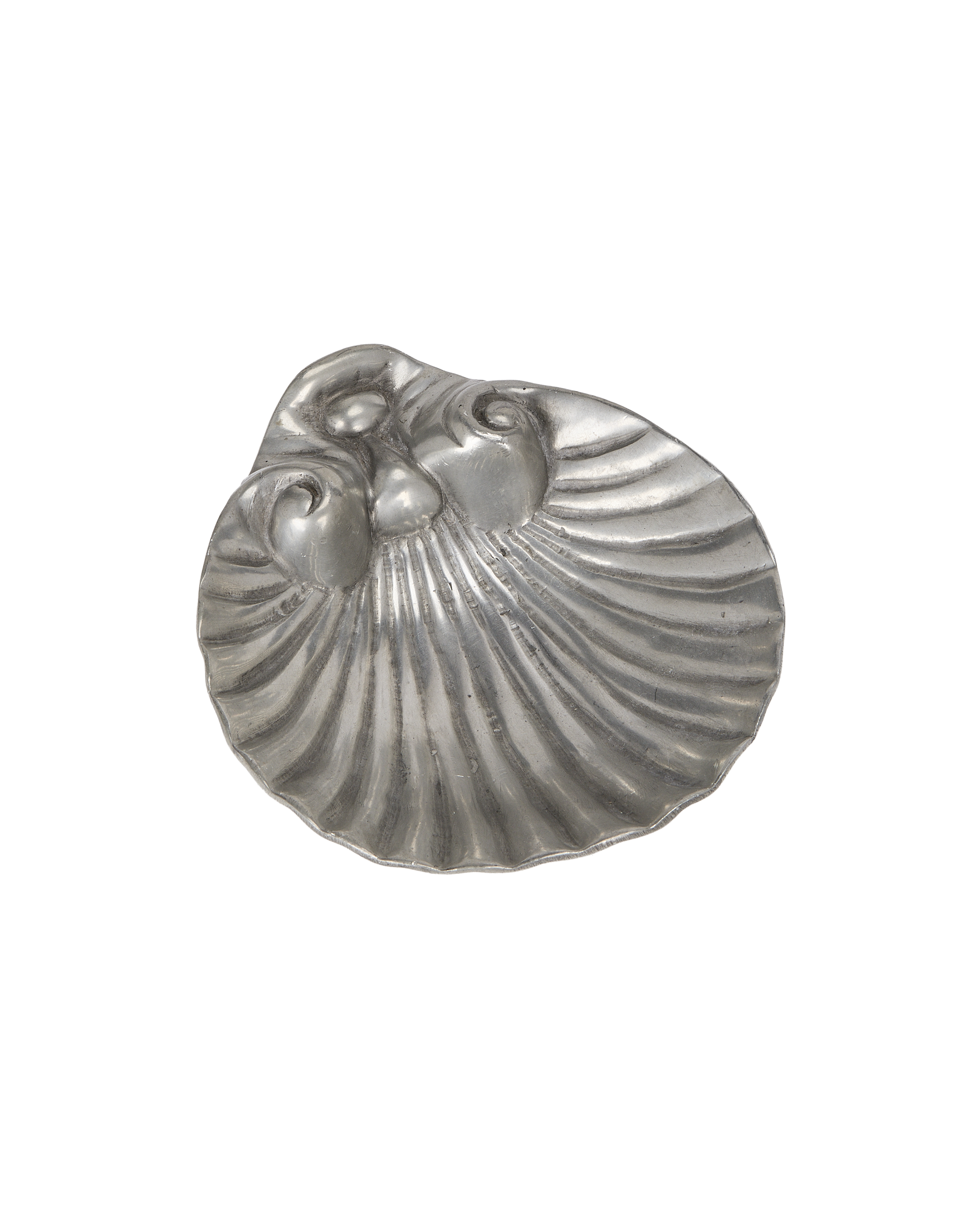 Vintage shell-shaped pewter vide poche from France exhibiting aged texture, top down view.