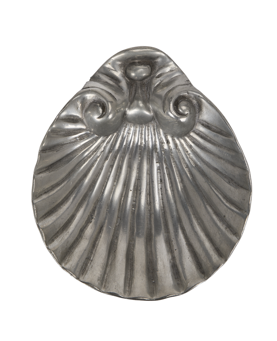 Vintage French pewter vide poche, shell-shaped, showcasing ribbed details and aged texture.