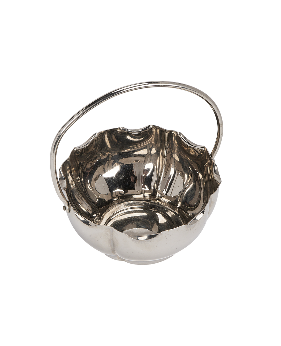 Vintage French silver-plated holder with swirled sides, showcasing reflective metallic luster and elegant handle.